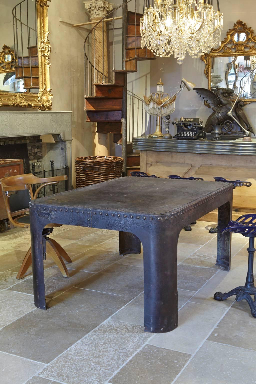 French Industrial polished weathered riveted steel table, made of an old water tank, Machine Age, circa 1900.