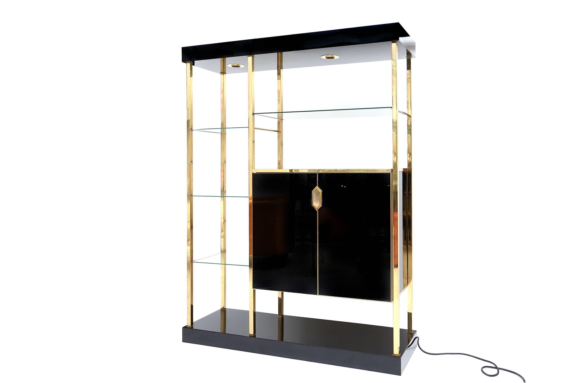 Beautiful room divider, etagere. Shelve system
Black Formica, brass, clear glass
The unit is entirely modular, so it's possible to arrange the cabinet either higher or lower.
Two lighting fixtures.
Hollywood Regency.
Measures: H 200 cm W 150 cm