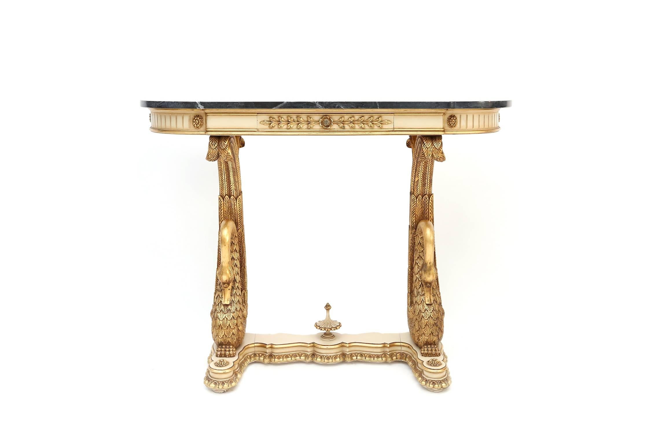 Carved Giltwood and marble-topped console table.

Swans, Fleur de lis. Regency Period, Italy.

Measures: L 130 cm, H 85 cm, D 35 cm.