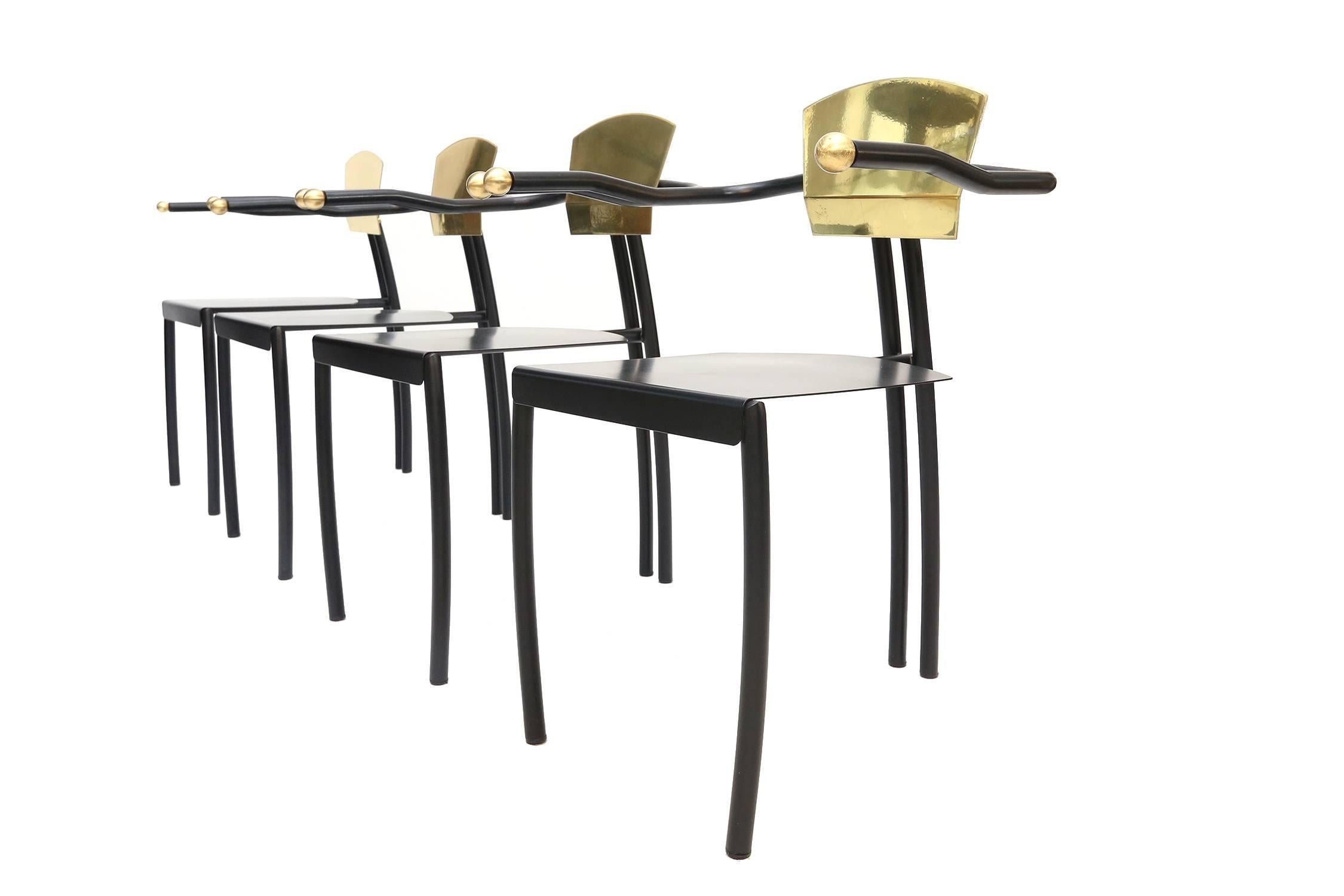 Set of four black lacquered metal and brass memphis style dining chairs. 

Late 1980s, early 1990s, model - Italy.

Measures: H 75 cm, D 45 cm, L 50 cm.