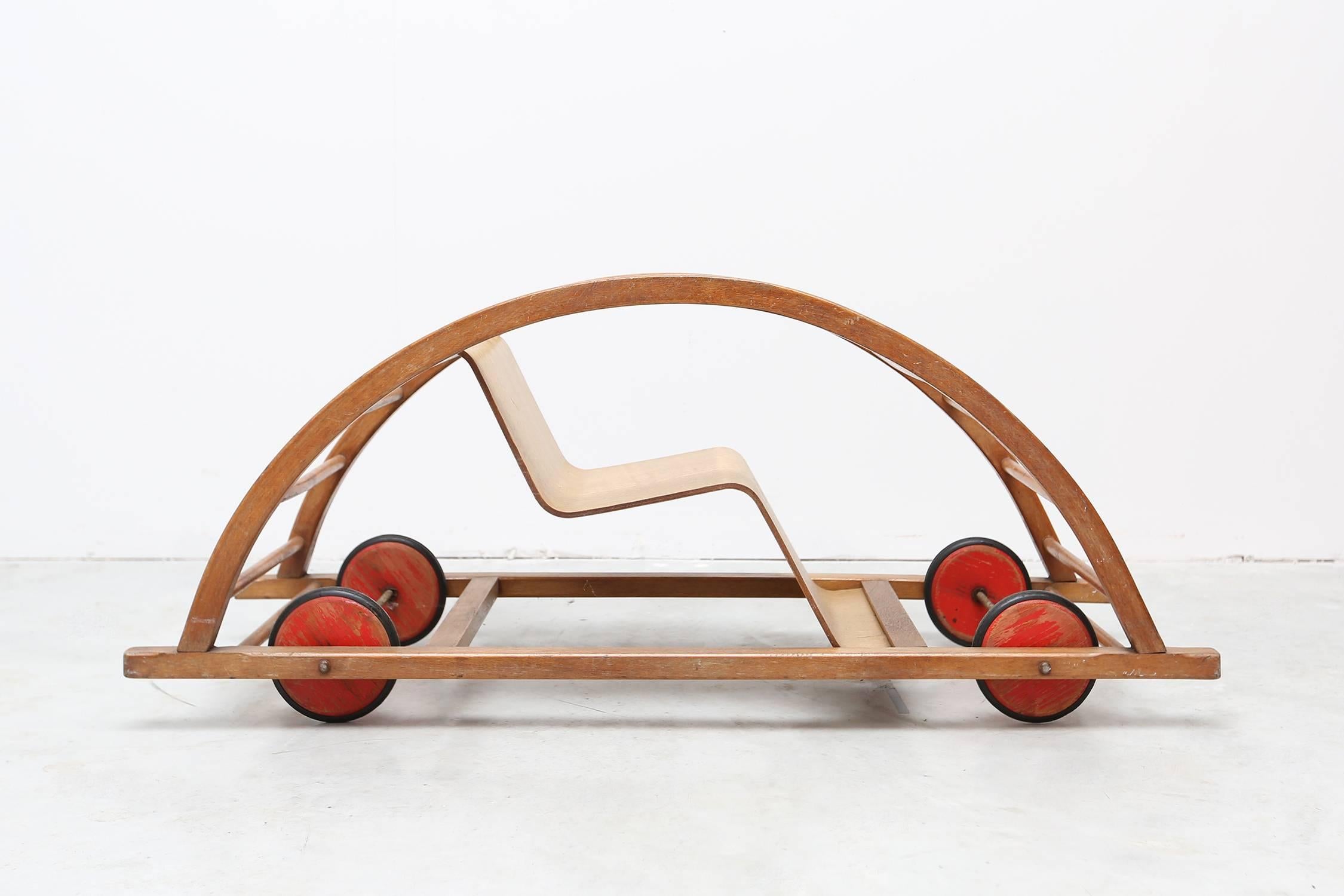 Mid-Century Modern Car toy by Hans Brockhage and Erwin Andra made in the early 1950s DDR. Design Classic for kids. 

Beechwood frame, curved plywood seating and red wooden wheels with rubber tires.

Measures: H 38 cm, W 100 cm, D 38 cm. 


 