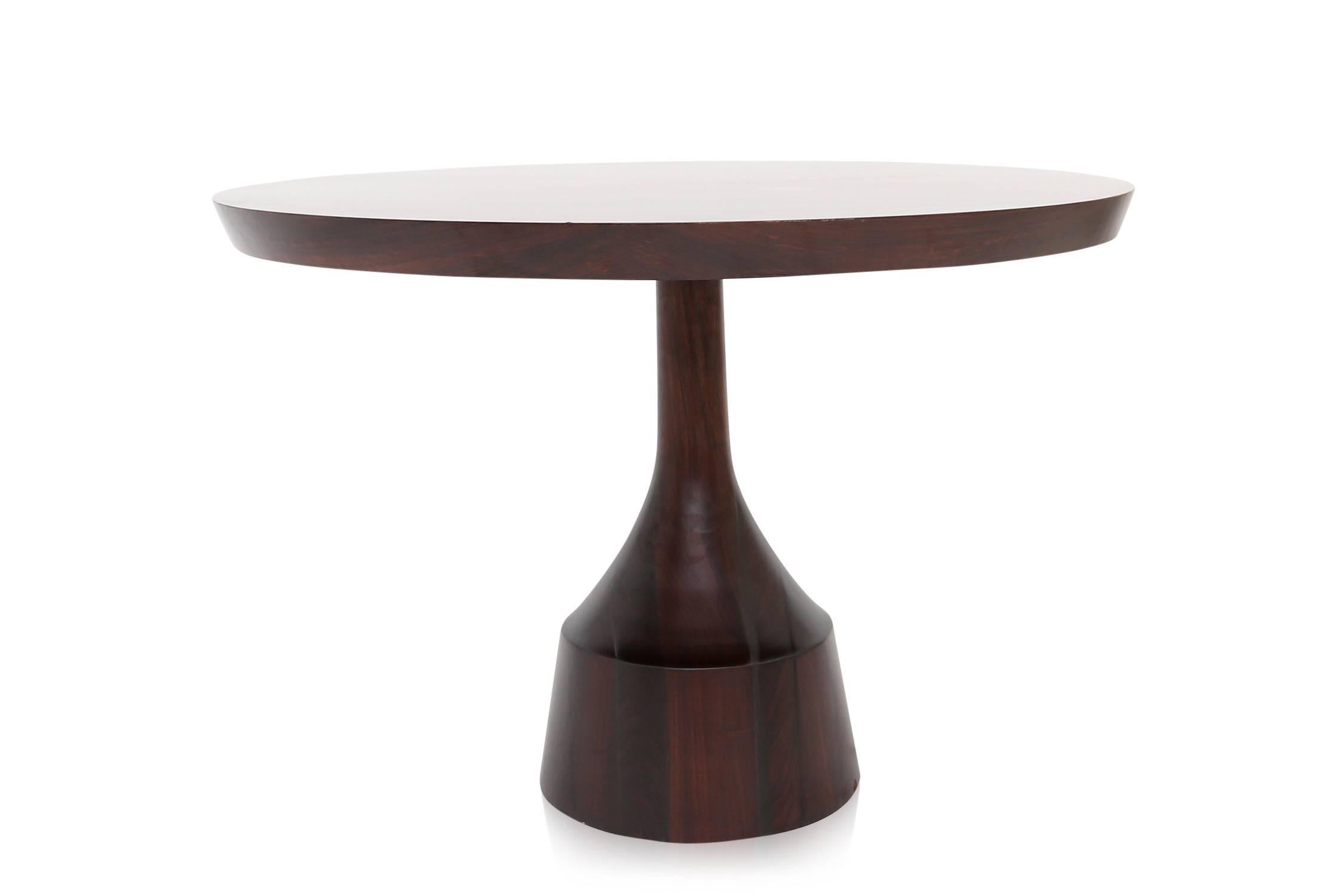 Mid-Century Space Age dining table.
Round rosewood top on sculpted rosewood base.

Italy, 1960s.

Measures: Ø 120 cm H 72 cm

                