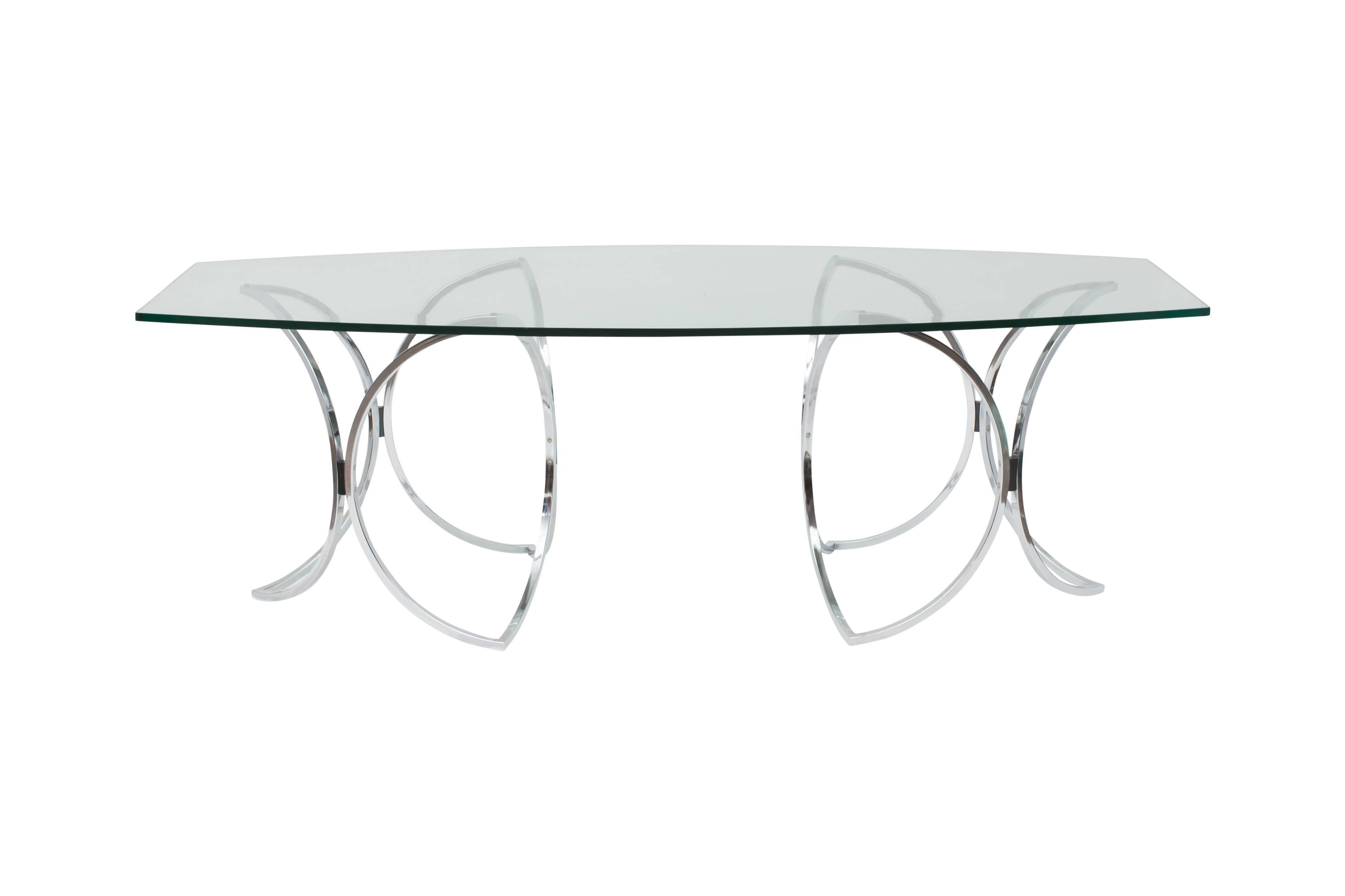 Extraordinary chrome and glass dining table
by Maison Jansen.

Graceful chrome feet support the heavy glass top.

Measures: W 220, D 100, H 73 cm.