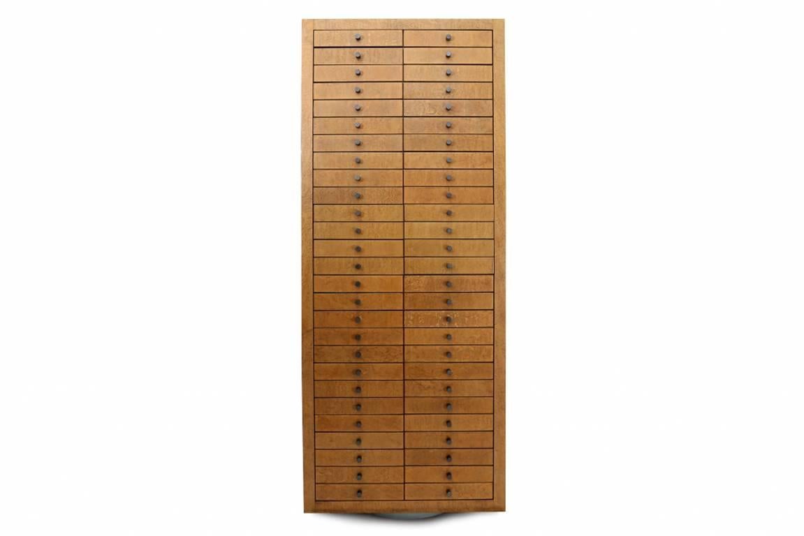 Oversized 54 drawer cabinet by Frans Can Praet, 1980s
This large multi-useable cabinet is provided with bird's-eye maple veneer,
and anodised hammered metal handles, which gives this cabinet a stunning modern look.
The cabinet stands on a round