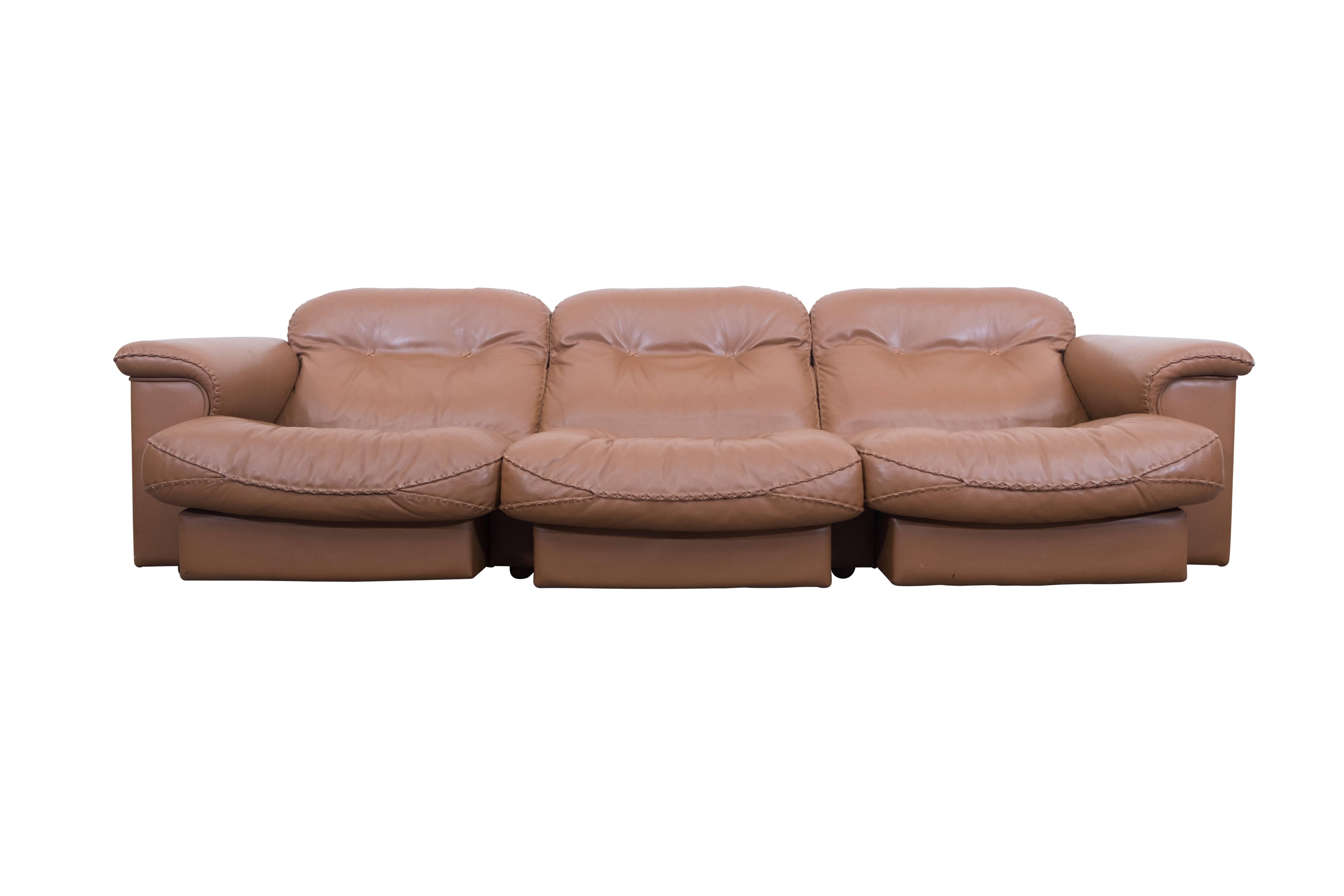 James Bond Cognac leather DS 101 Sofa by De Sede

Adjustable and very comfortable sofa by De Sede, Swiss, 1960s
The chairs are upholstered in very high quality leather and finished with interesting
thick stitched seams.

Side note:
The De Sede DS