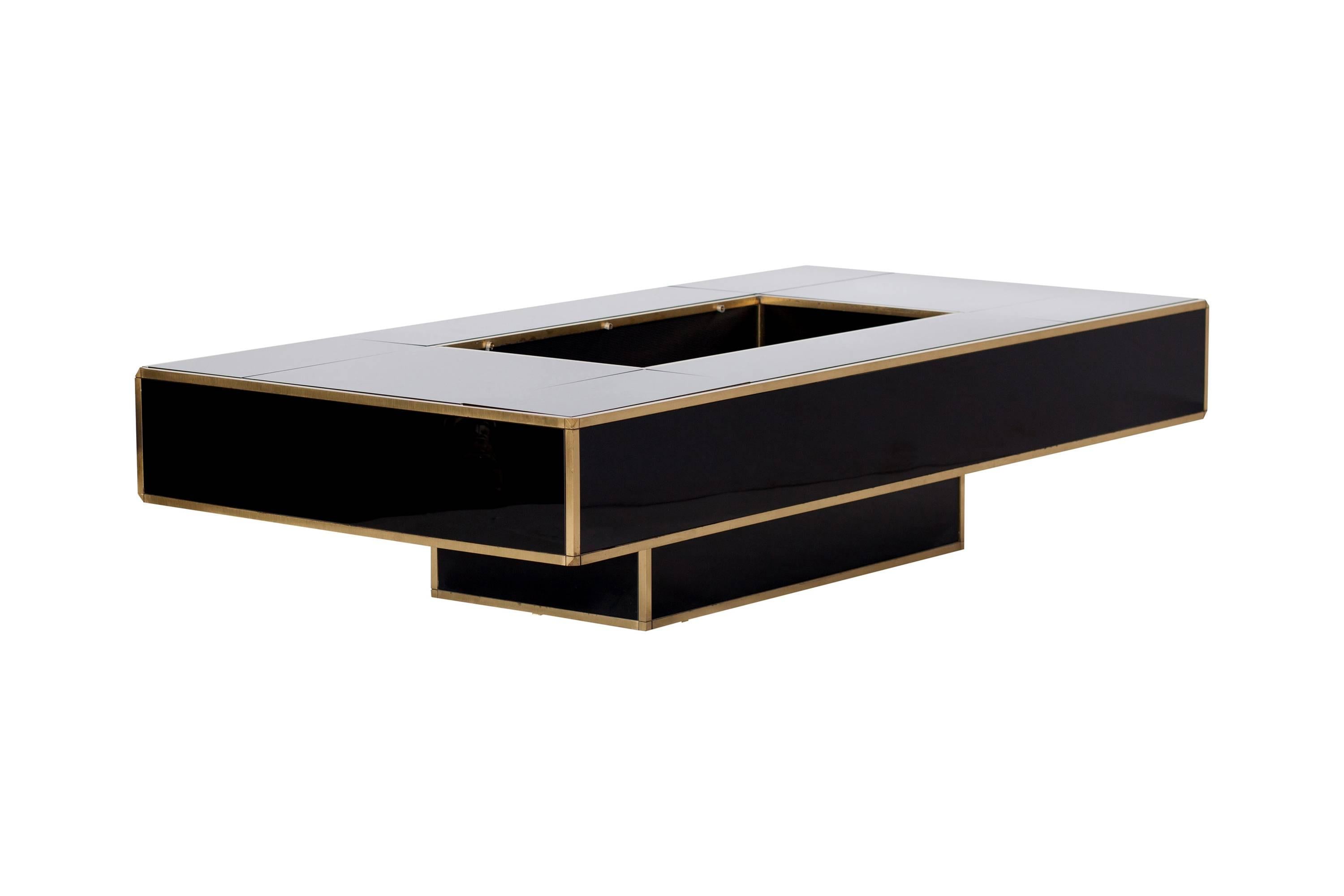 Large and extraordinary Mario Sabot coffee table in black smoked glass. 
The table features a stunning brass frame and hides a large bar compartment. 

Tributed to Willy Rizzo.

Italy, 1970s. 

Measures: W 160 x D 80 x H 40 cm. 

 