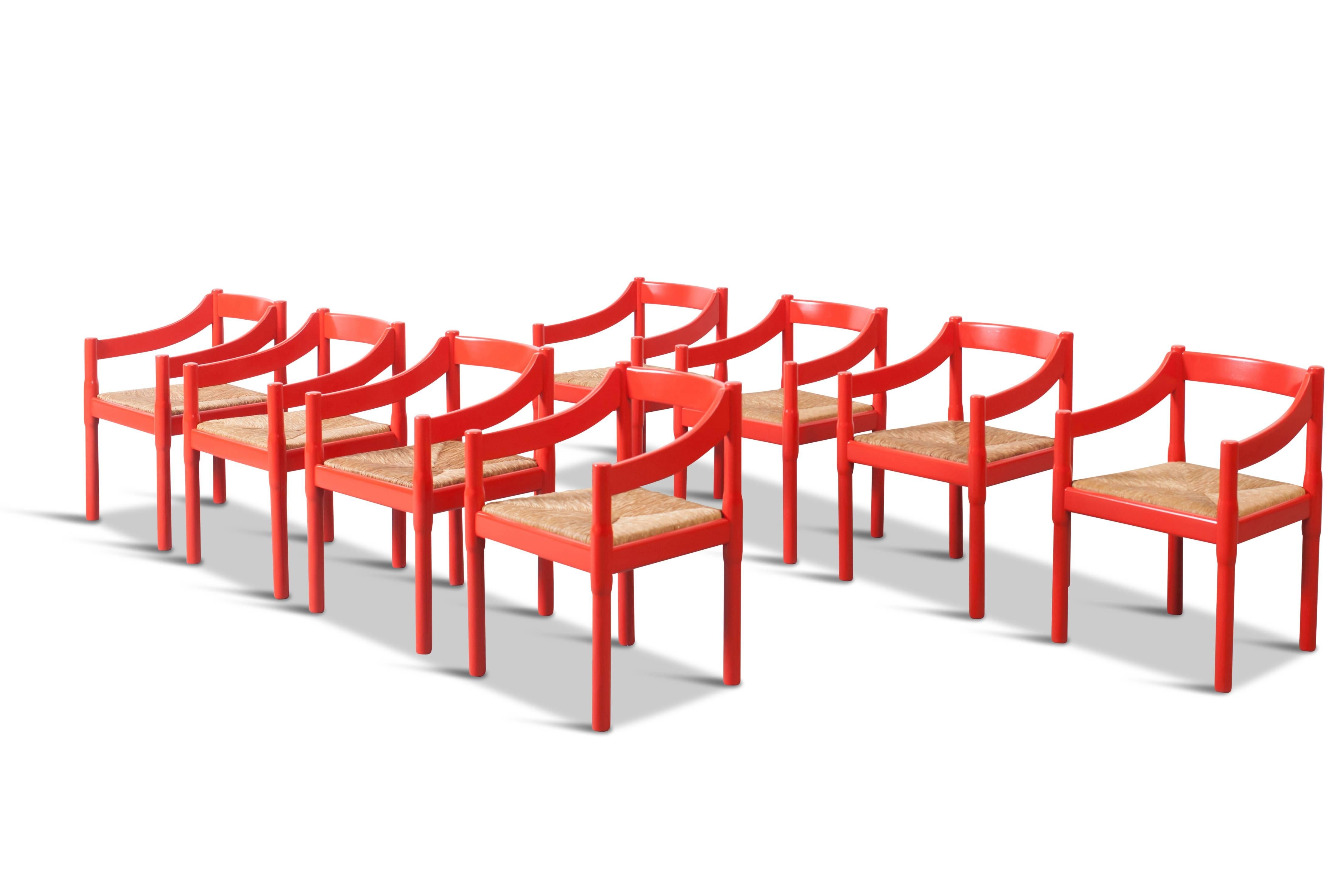 Set of eight 'Carimate' chairs, in beech and rope
by Vico Magistretti for Cassina

A true iconic design with a simple and elegant shape 
the gently curved arms and woven seats provide great comfort

Red lacquered beech wooden frames and natural