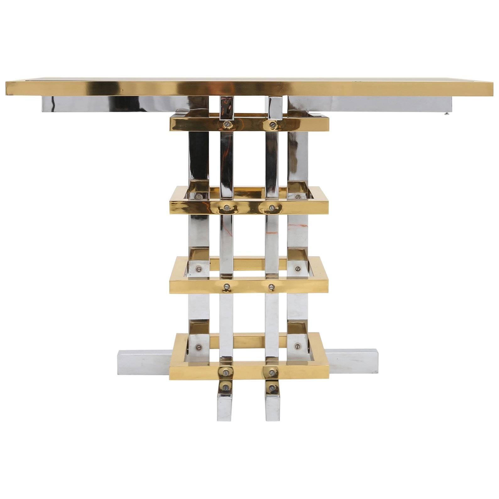 Brass and chrome console table, style Maison Jansen.
by artist Duchise. Knokke, Belgium, 1970s.
Would fit well in an eclectic interior inspired by Pierre Cardin, Romeo Rega or Willy Rizzo.

Brass and chromed metal. 
Smoked mirrored glas