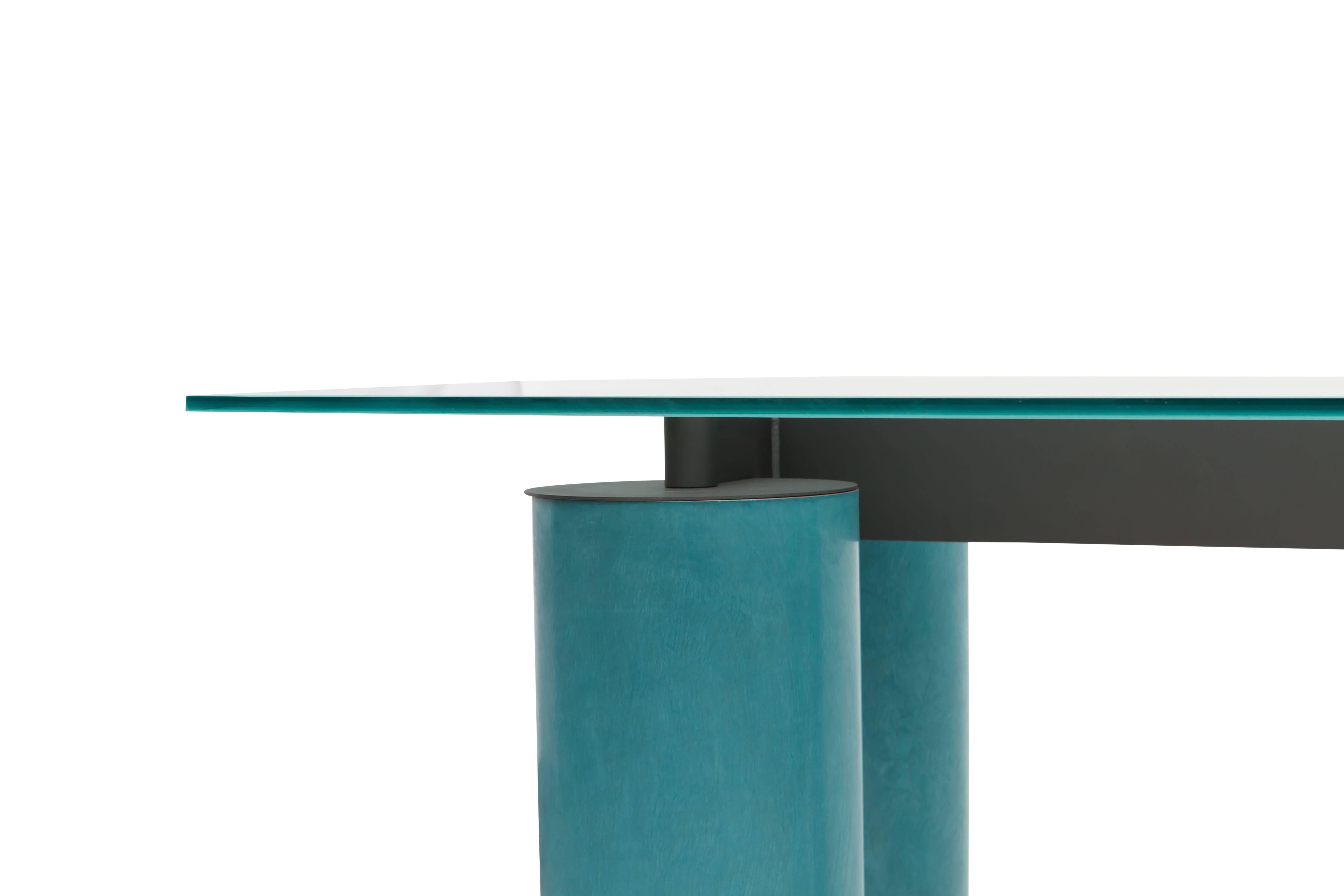 Memphis eighties style desk or table manufactured by Acerbis and designed by David Law, Lella and Massimo Vignelli.
An opalescent crystal top on a turquoise cylindrical base.
Measures: H 72 cm x D 100 cm x W 200 cm.
