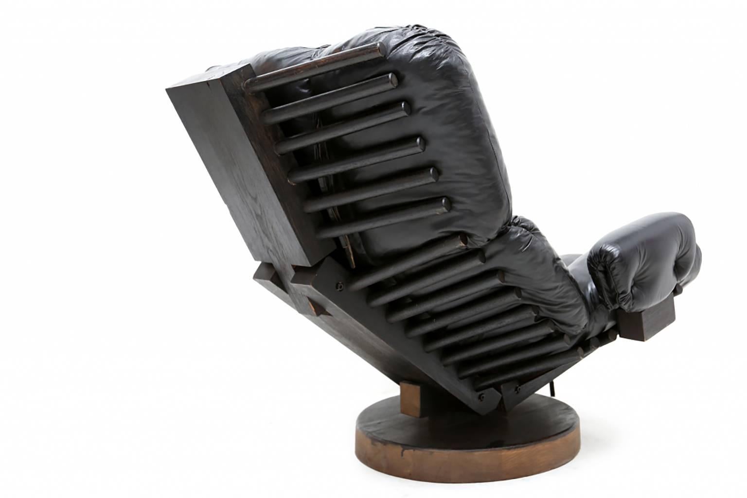 Mid-Century Modern leather easy chair, wooden vertebra ribbed base on a hardwood swivel.

In the style of Martin Eisler & Carlo Hauner.

An exceptional high-end item, engineered and designed for maximum comfort.
   
