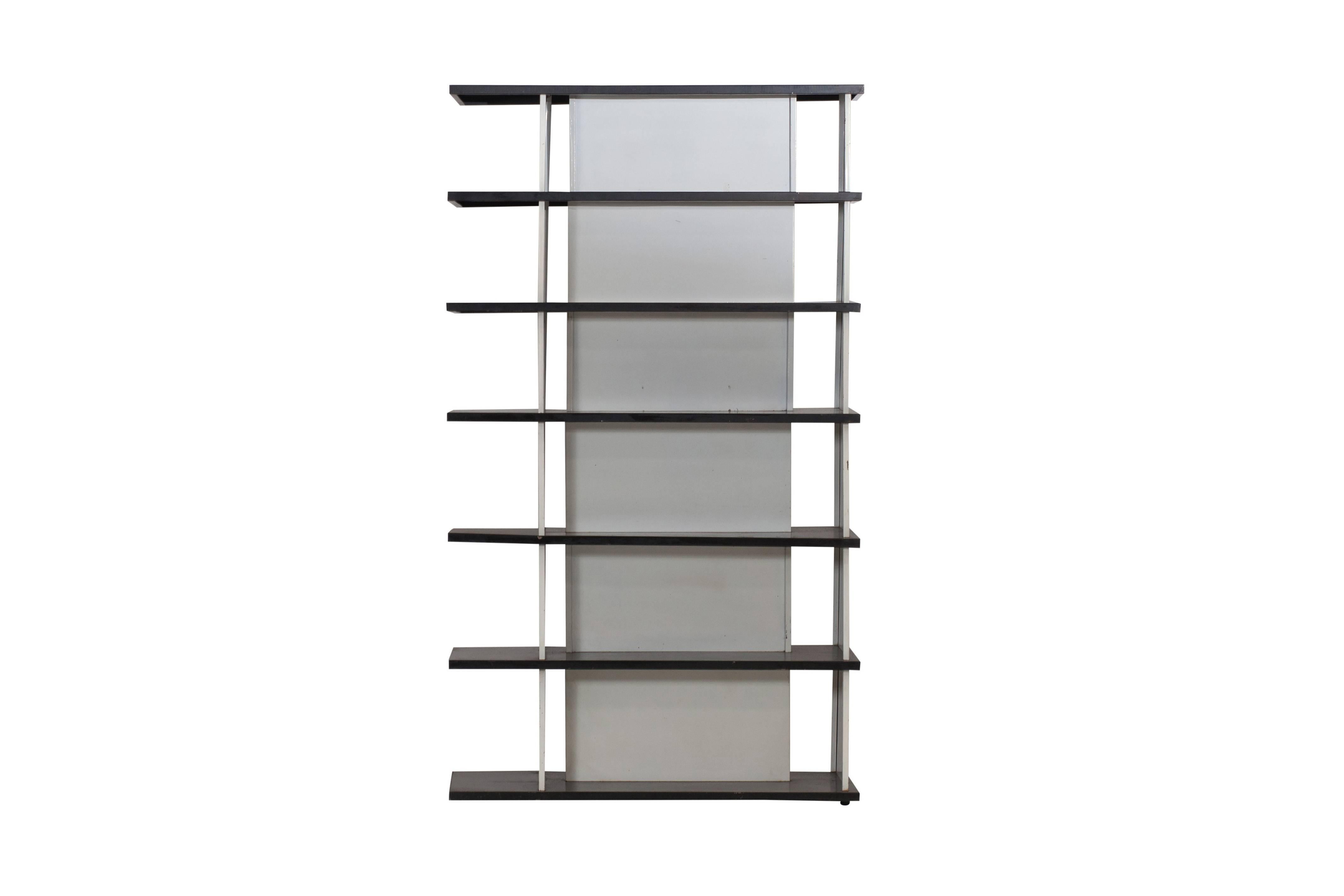 Minimalist Industrial design bookcase or room divider by Industrial designer Wim Rietveld, son of Gerrit Rietveld. The origin of this bookcase was a big question, but it was made for exclusive department store De Bijenkorf in 1960. De Bijenkorf sold