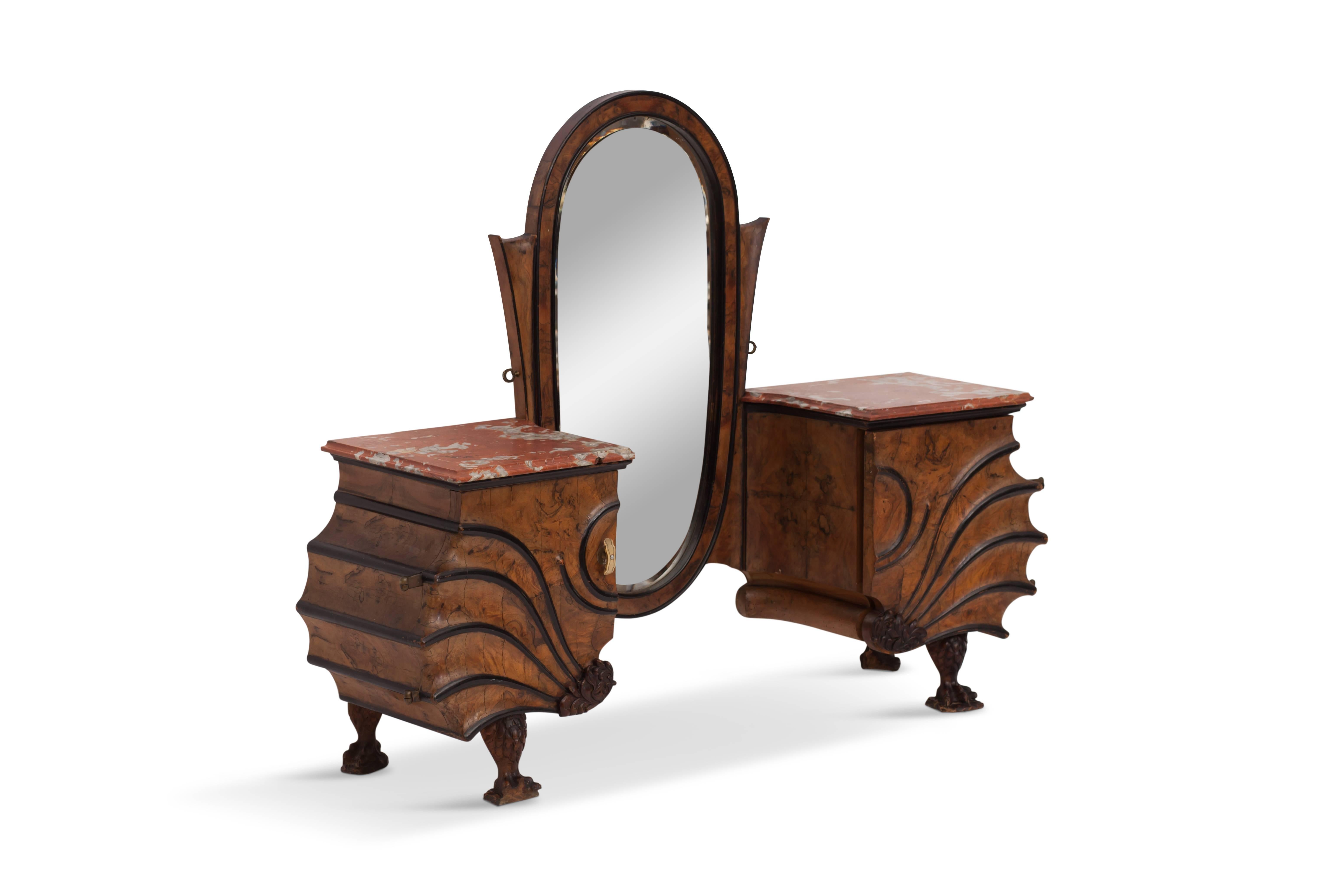 High-end walnut and ebony vanity table

This eclectic and exuberant piece shows a beautiful form
with stunning details such as the hand carved claw feet 
and flower motives

The sides have a red and white marble top
very solid brass door