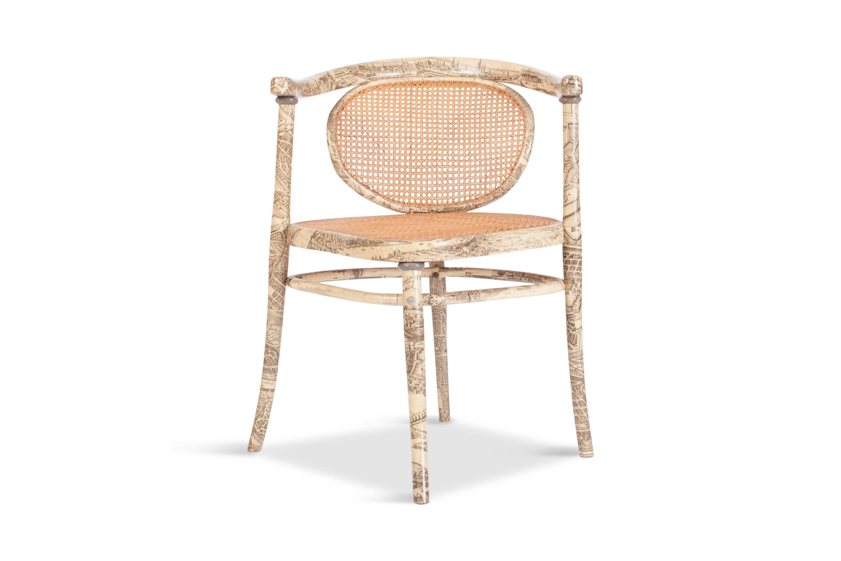 Thonet armchair 

The seat and backrest are weaved in rattan. The rest of the frame is covered in a print
inspired by Fornasetti. The chair is marked on the inside of the seat,

Europe, 1950s.

Measures: W 68, D 66, H 79, SH 46 cm.