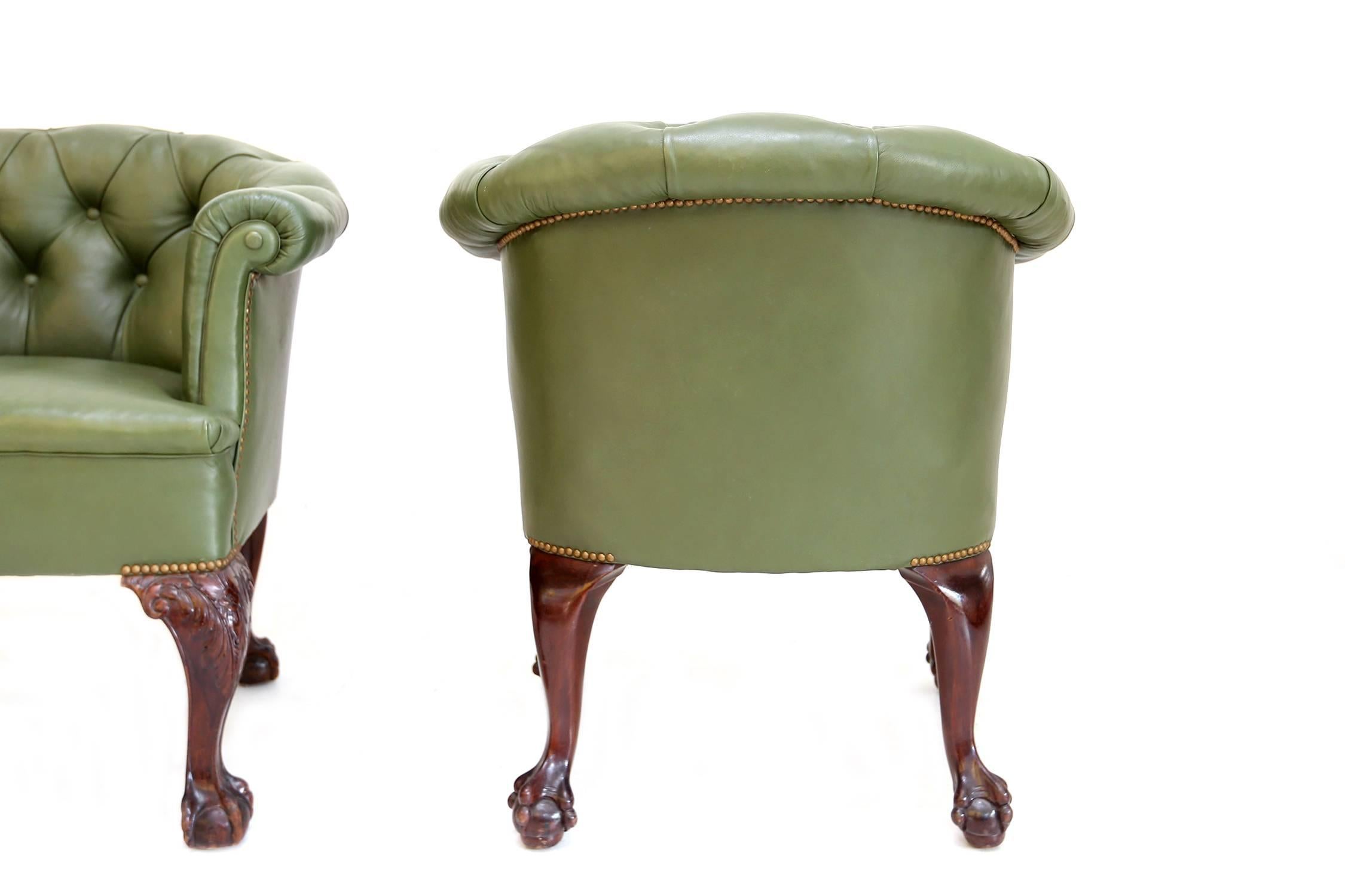 Green leather Chesterfield club chairs.
Attractively disproportional mahogany feet,
UK, 1960s.
 