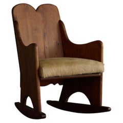 Fauteuil à bascule en bois dans le style d'Axel Einar Hjorth – années 1930