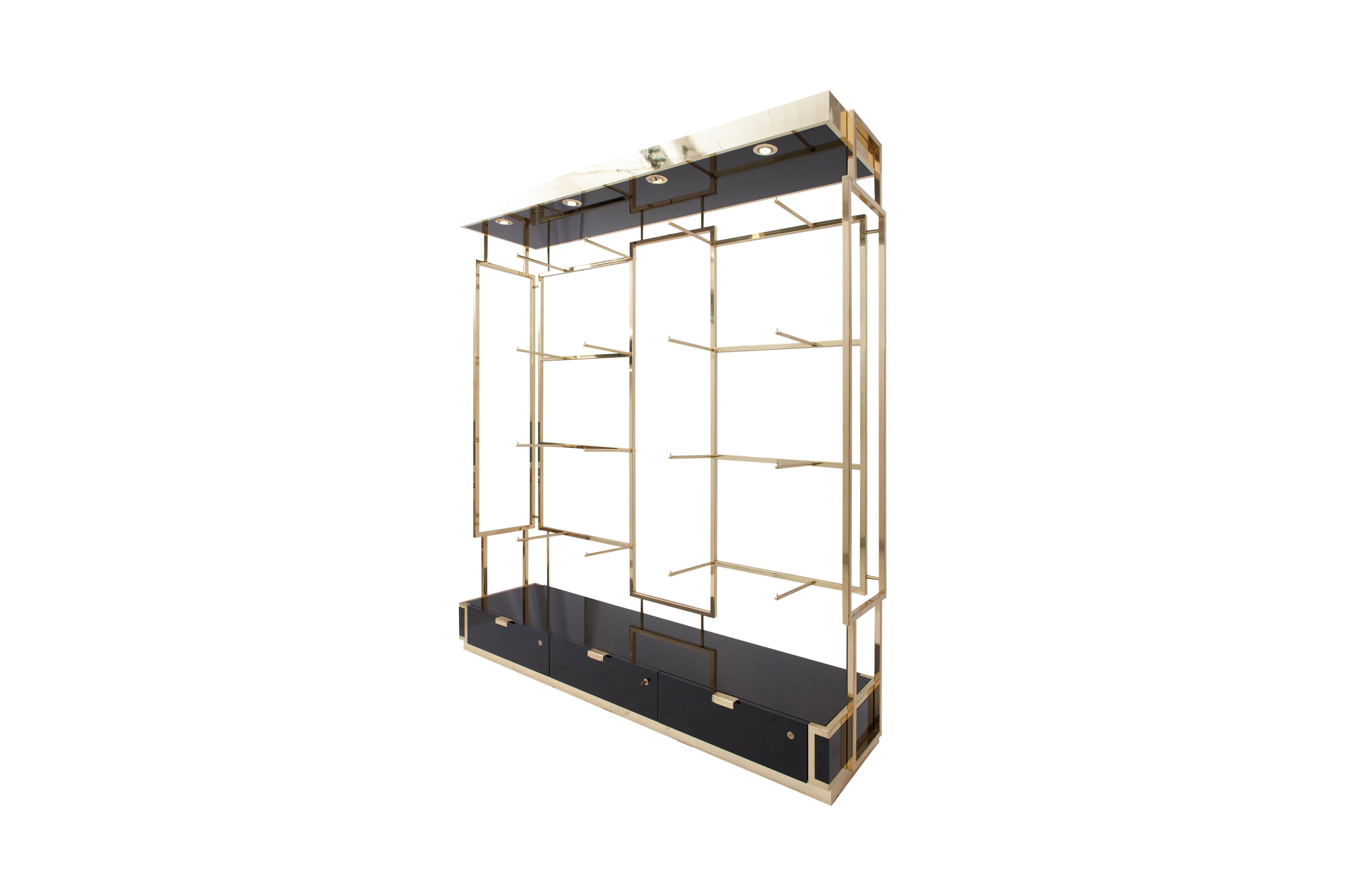 High-end display unit in black lacquer and brass.
Three drawers. Multiple brass hangers which could also support glass shelving.

Finished at the back, so this étagère could be used a a room dividing system, as well as a wall unit.

Excellent