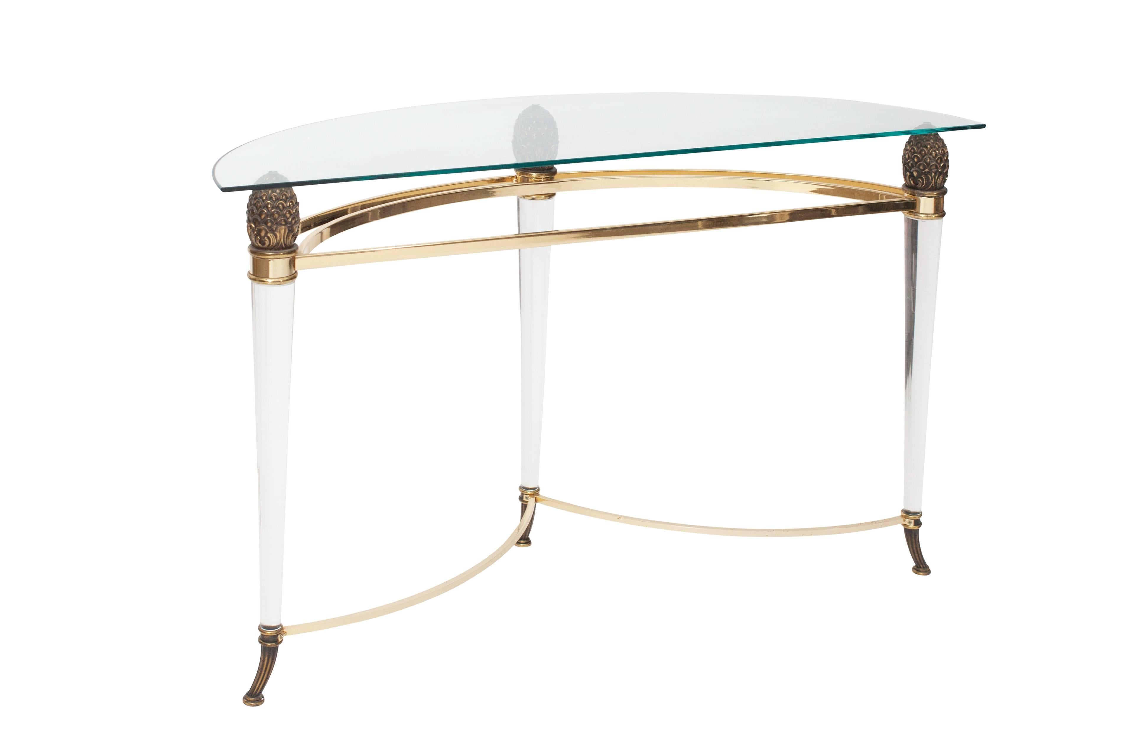 Elegant console table in lucide, brass with glass top by Maison Jansen.
On top of the lucide legs, well crafted brass pine cones are placed that
support the glass tabletop, which are also (together with the the legs)
beautiful details of this