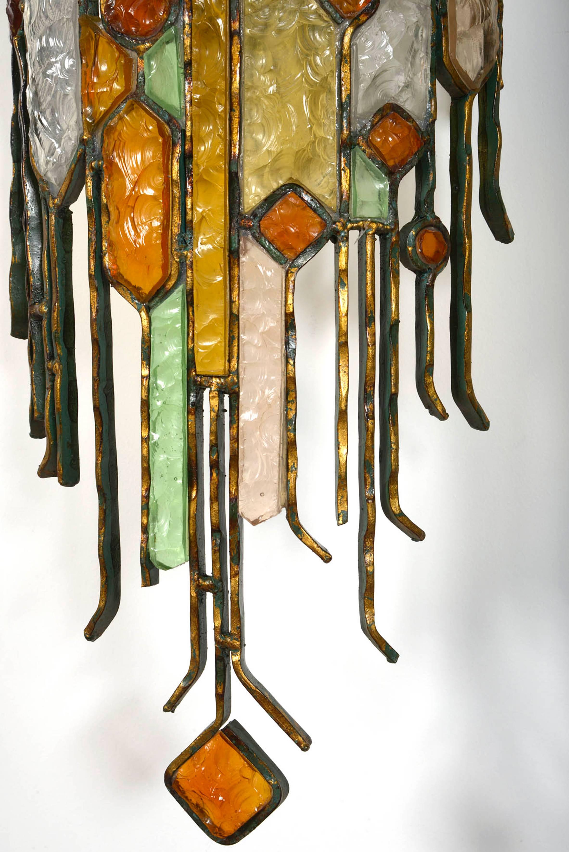A very large pair wall lights in the style of Poliarte.
Carved colored glass and patinated iron.