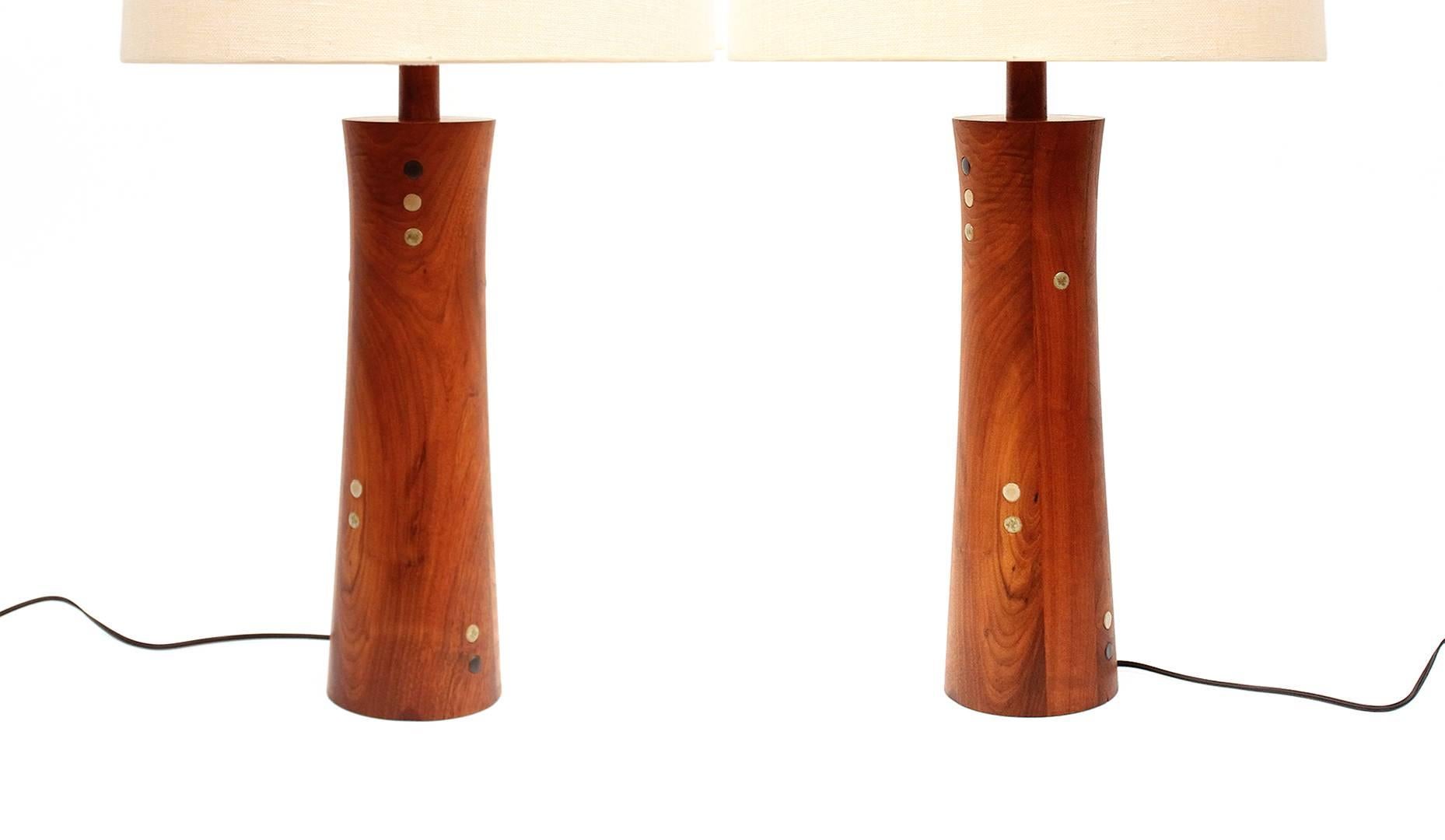 Exquisite pair of table lamps in walnut with inset circular ceramic tiles designed by Jane and Gordon Martz for Marshall Studios.  Rare pair of mixed material lamps from this husband and wife design duo. Lamps include the Martzes iconic wooden
