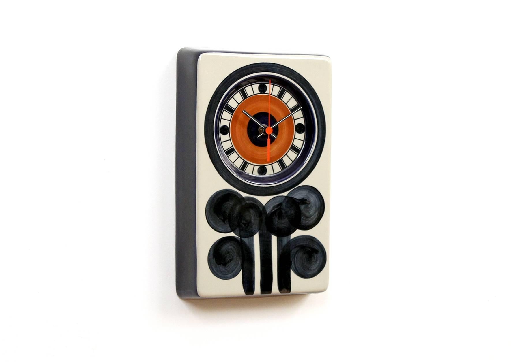 Graphic ceramic clock designed by Marianne Westman for the Swedish company Rorstrand. Westman designed a variety of colorful objects for Rorstrand over 20 years with the company. Clock is running and keeping time. Signed with stamp to the reverse