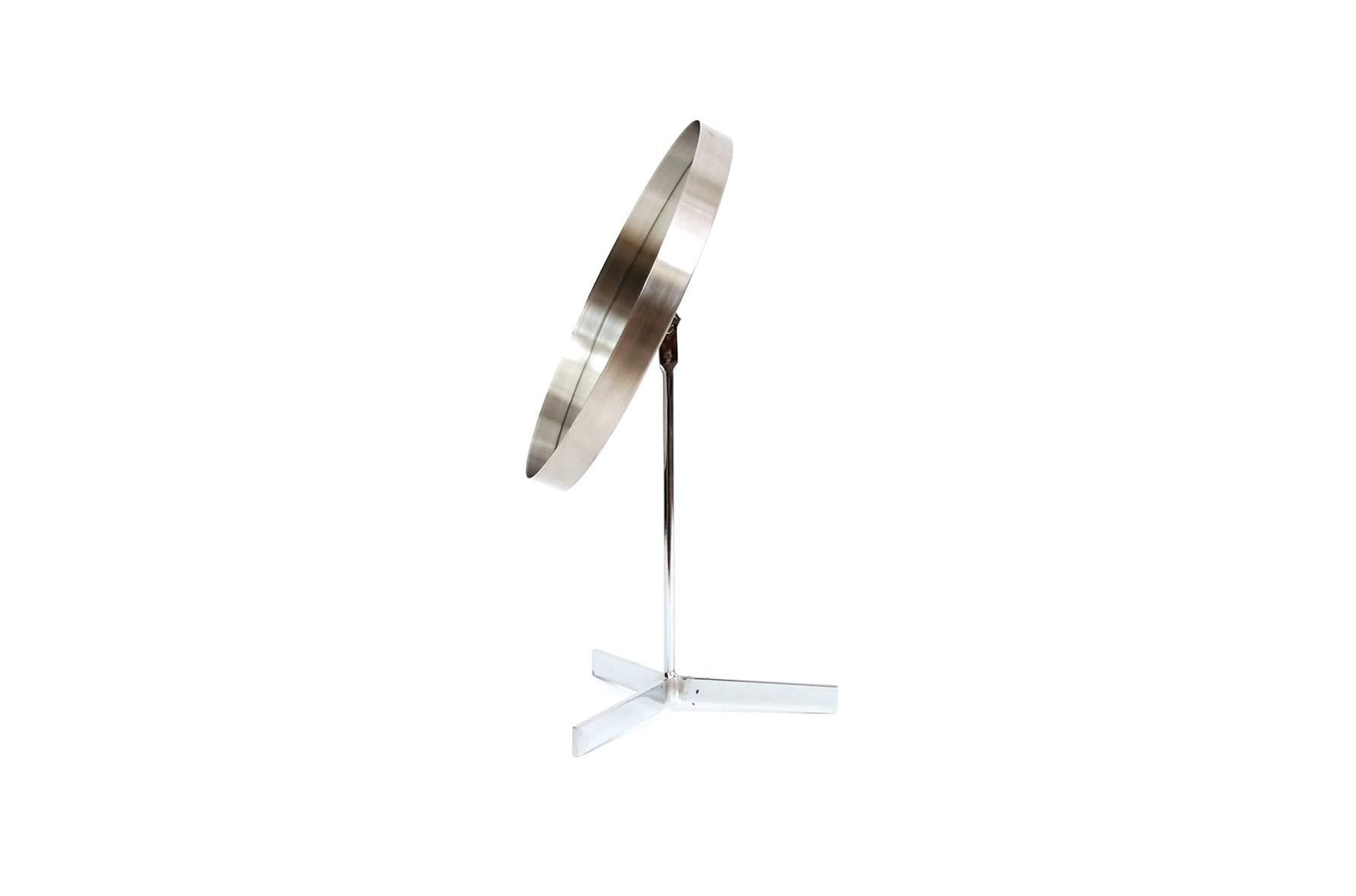 Table or vanity mirror in the style of the Swedish company Luxus. This particular example in chromed steel. Produced by Durlston in the 1960s. Attractive cantilevered design and useful form.