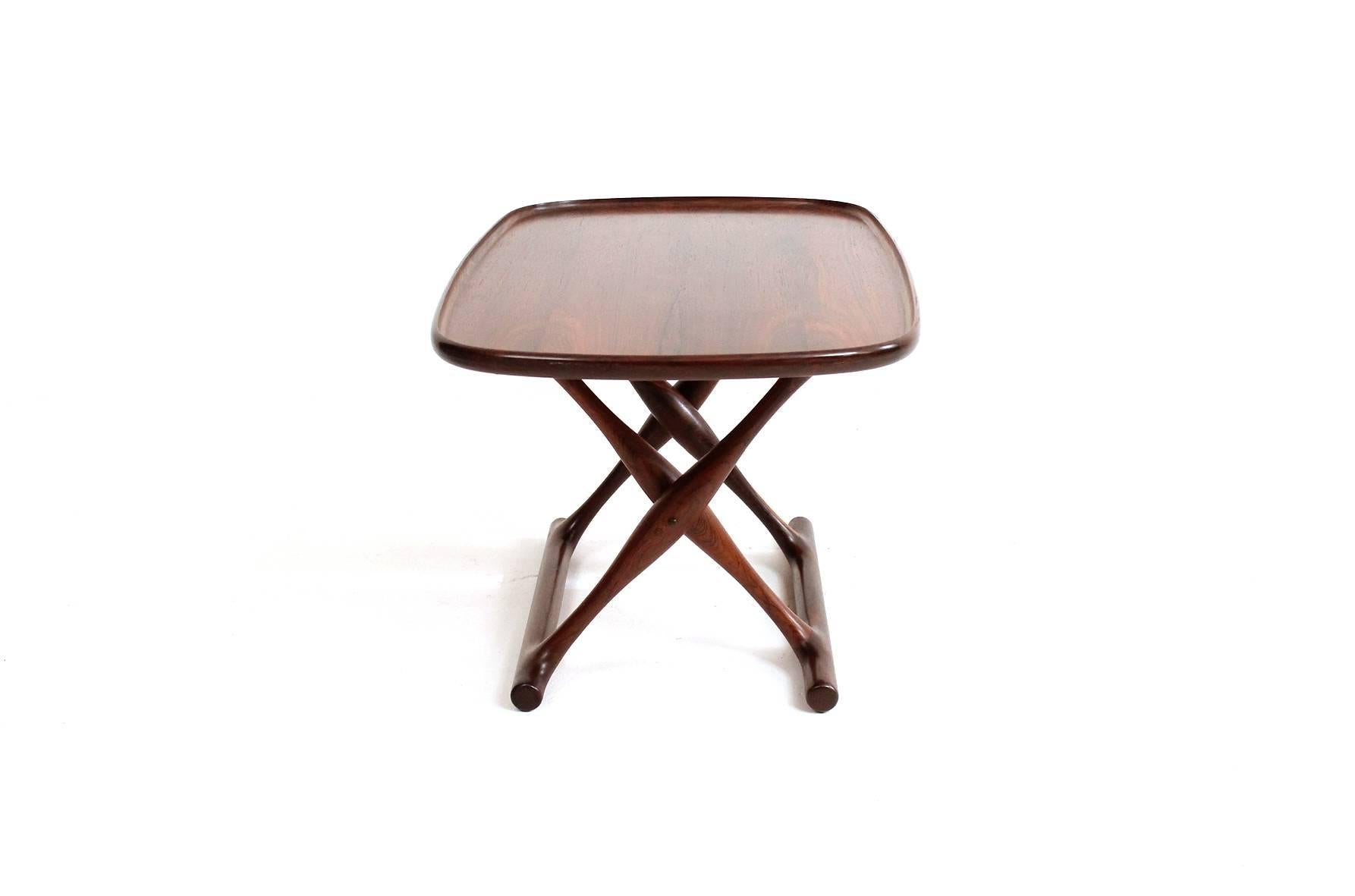 Guldhoj rosewood tray table and leather folding stool designed by Poul Hundevad. Finely grained rosewood table top and attractive patina to the brown leather of the folding stool.  Signed with the manufacturers decal to underneath of the tray top.