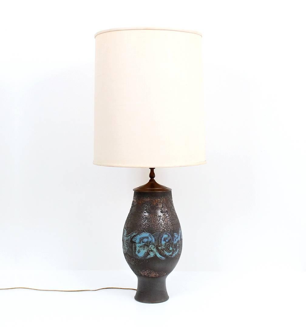 Large pottery lamp by noted midcentury ceramicists Edwin and Mary Scheier.  This example from 1966 decorated in the sgraffito technique with anthropomorphic designs of human and animal heads and a textured metallic glaze. Excellent and