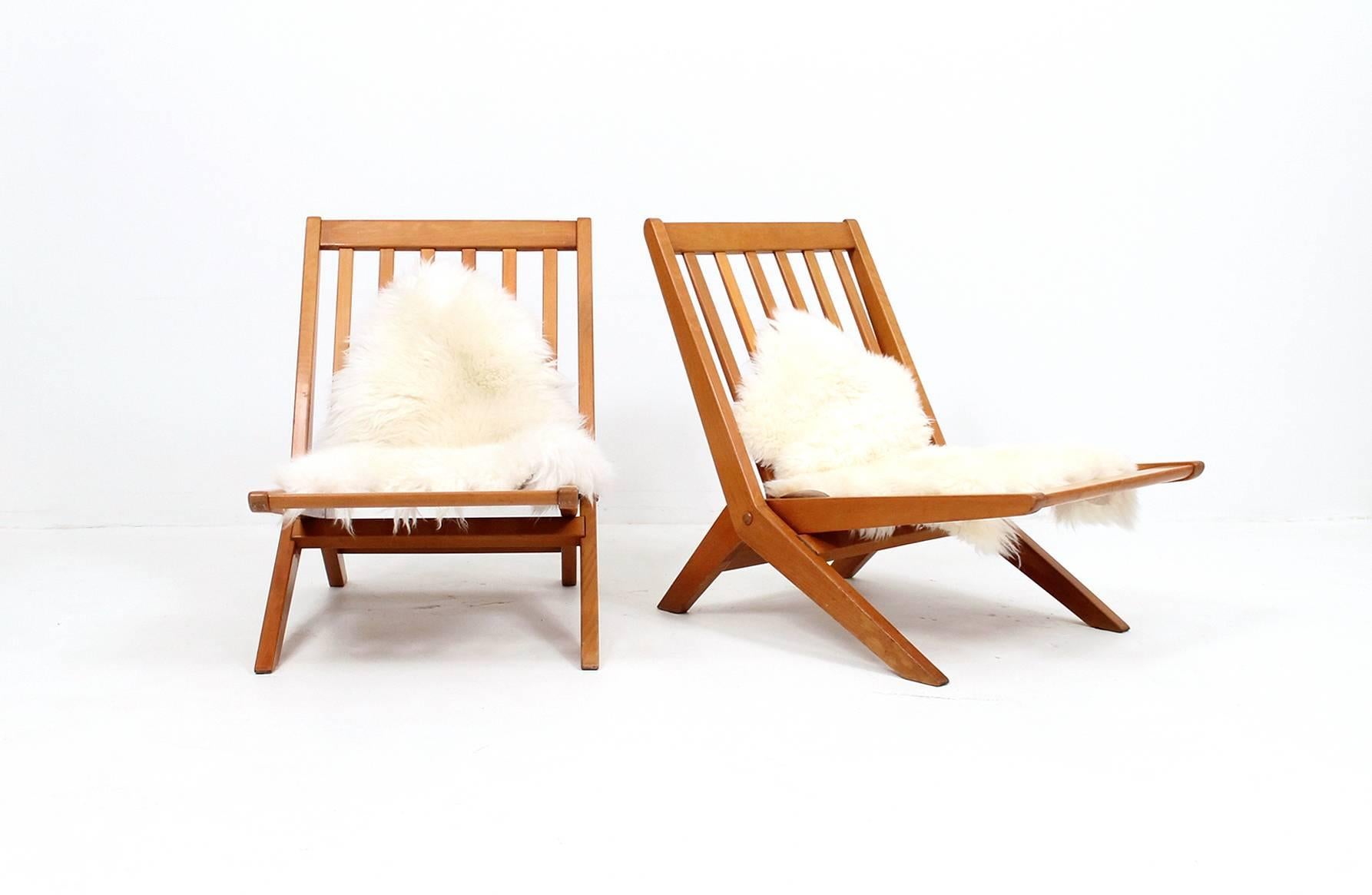 Pair of rare Peter Hvidt + Orla Molgaard-Nielsen folding scissor chairs for France + Daverkosen. These are Model No. 171. Chairs fold for easy storage. Comfortable seating with the addition of a sheepskin as a cushion.
