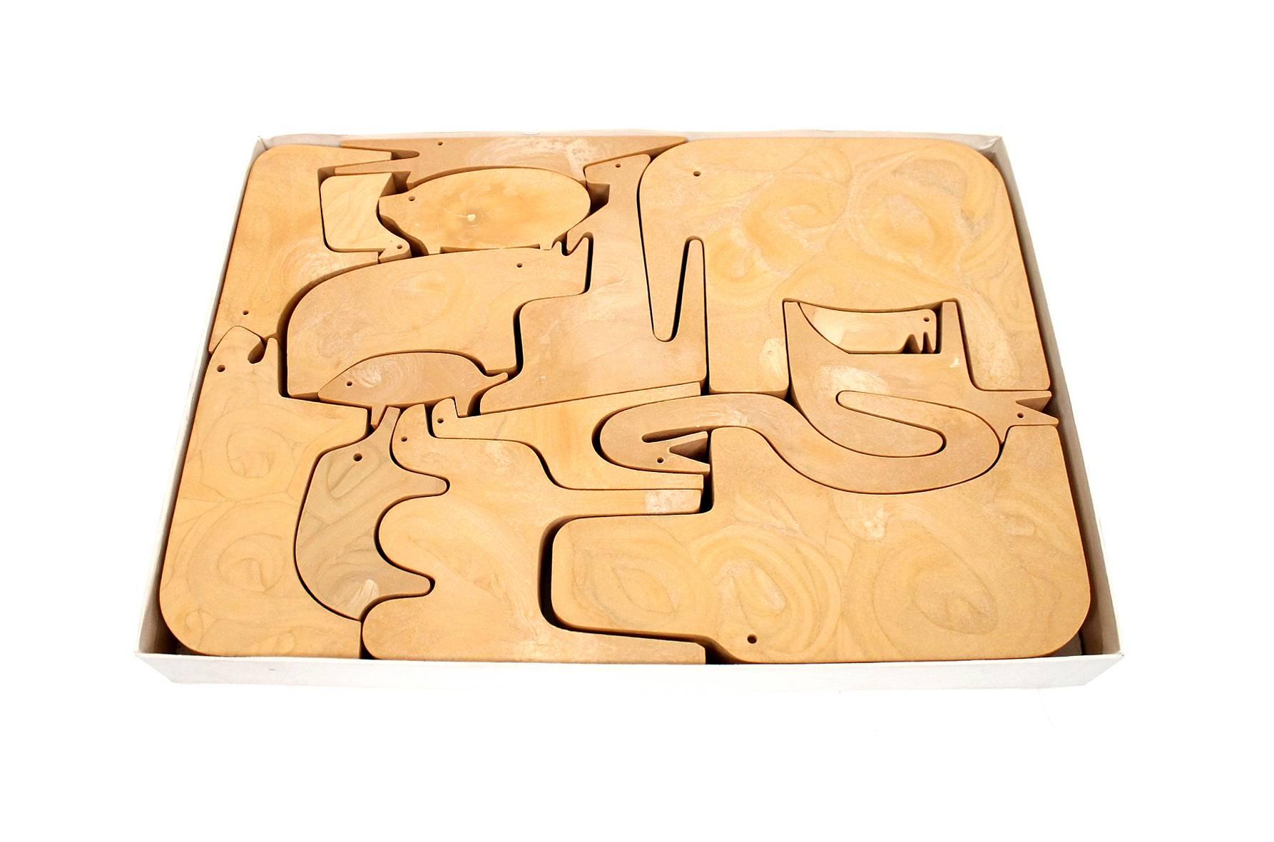 Two puzzles designed by noted Italian designer Enzo Mari for Danese. One in resin with its original box and the other smaller puzzle in the rare teak variation.  Fun and playful animal designs. Priced individually. Dimensions below are for resin