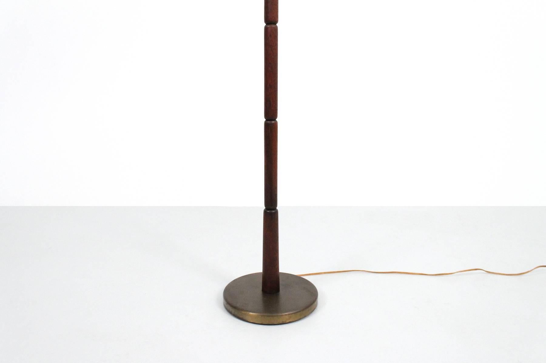 Early Stewart Ross James designed floor lamp for Hansen Lighting NYC.  Elegant details with segmented wooden shaft and period bakelite switch.  Signed in handwritten script to underneath of the base. This lamp is being sold without an original