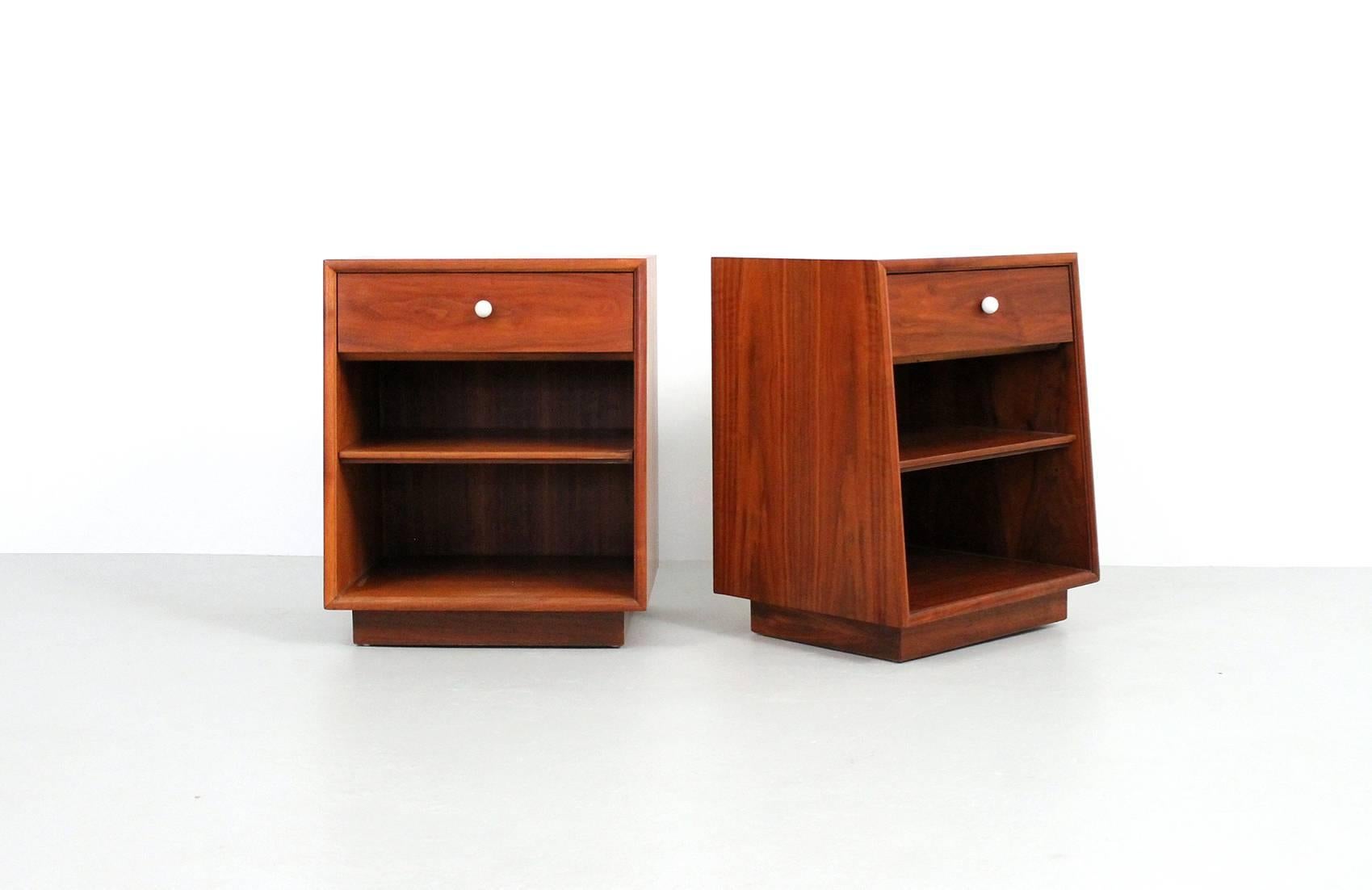 Walnut nightstands designed by Kipp Stewart for Drexel. These are from Drexel's Declaration line. Attractive and functional, both stands retain their original white porcelain pulls and adjustable shelf.
     