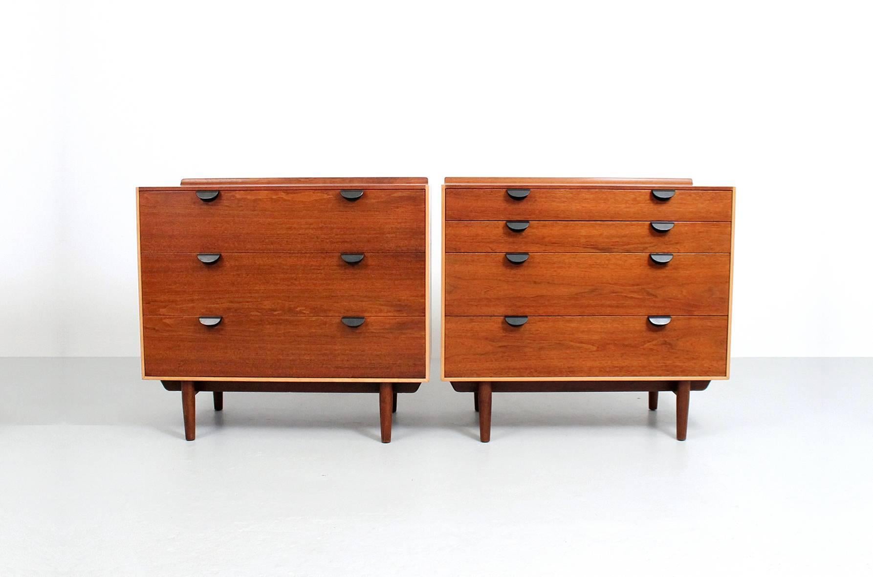 Pair of walnut and birch dressers designed by Finn Juhl for Baker.  Each dresser with walnut drawers and tops, enameled brass pulls, walnut bases, and birch sides.  Desirable and useful pair of dressers.