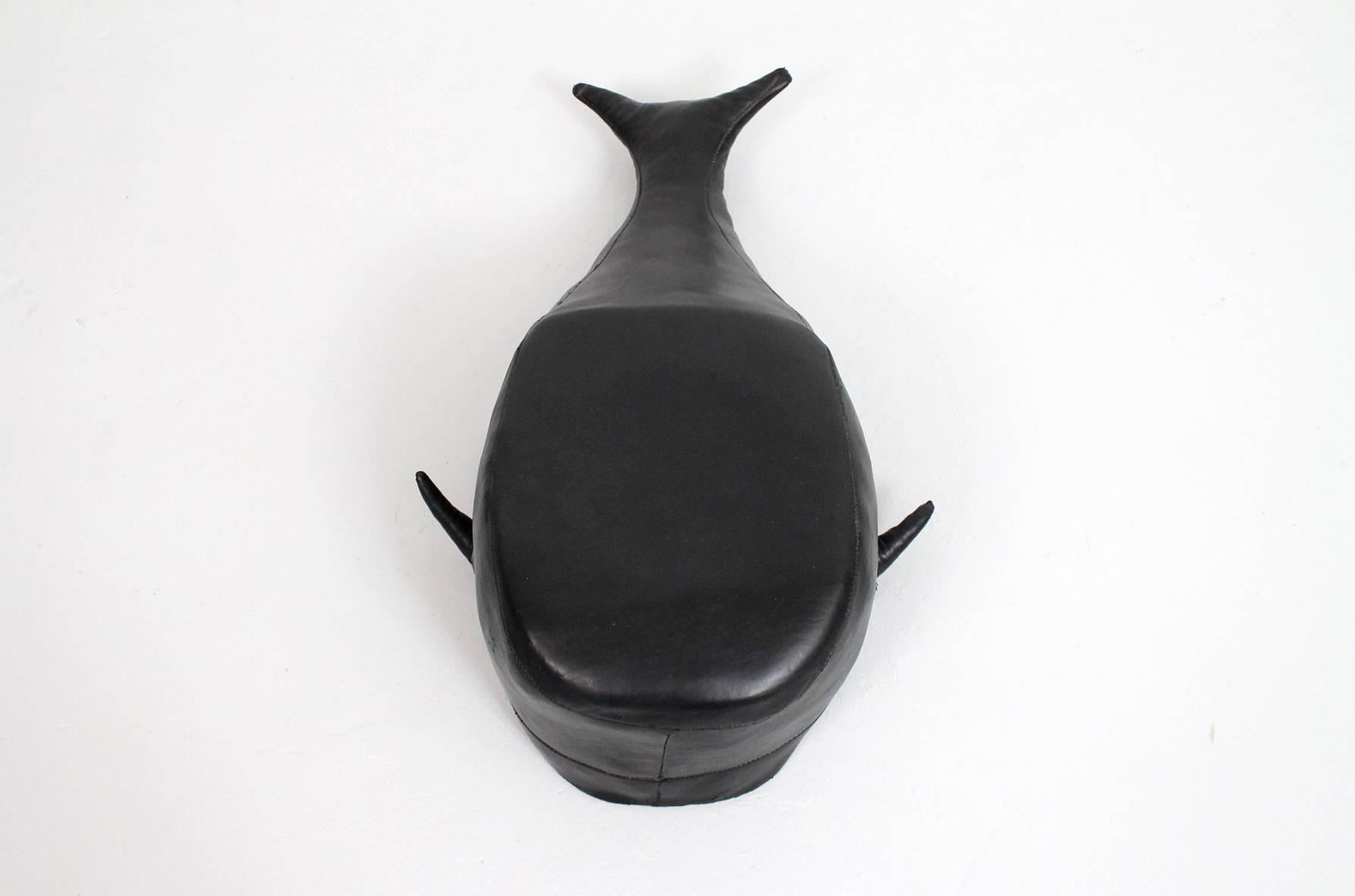 English black leather pouf or ottoman in the shape of a Sperm whale. Marked Made in England to the underside.