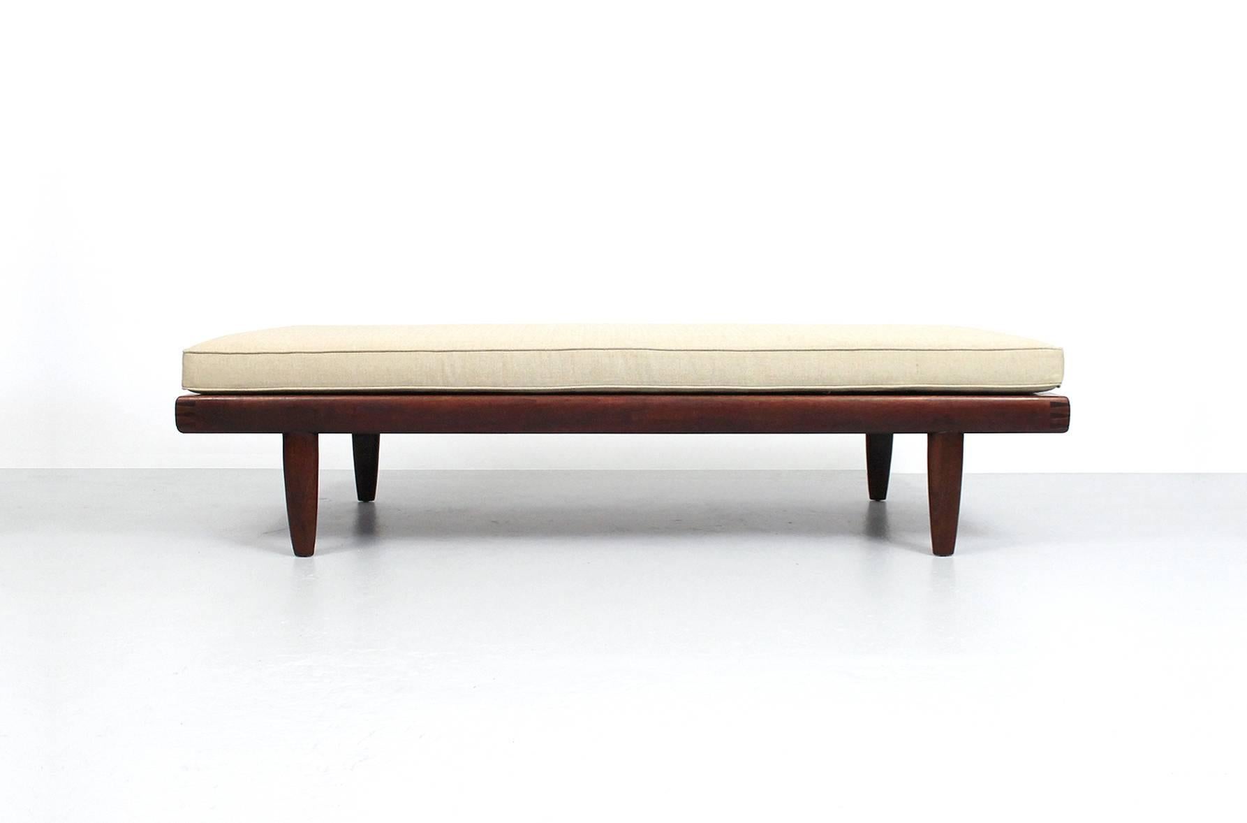 George Nakashima coffee table or daybed with upholstered loose cushion. This piece is from the Sundra line for Widdicomb. Characteristic use of walnut and rosewood with dovetail joinery. Branded to underside.