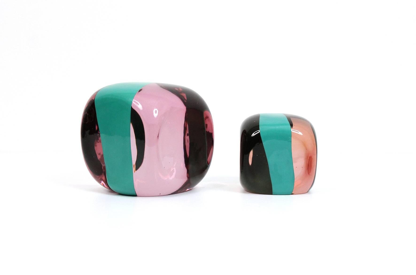 Graphic pair of Pierre Cardin designed glass paperweights for Venini. This series by Cardin was produced in the 1980s. Both with etched signatures to undersides. Dimensions below for larger of two paperweights. Smaller of two is 3.25
