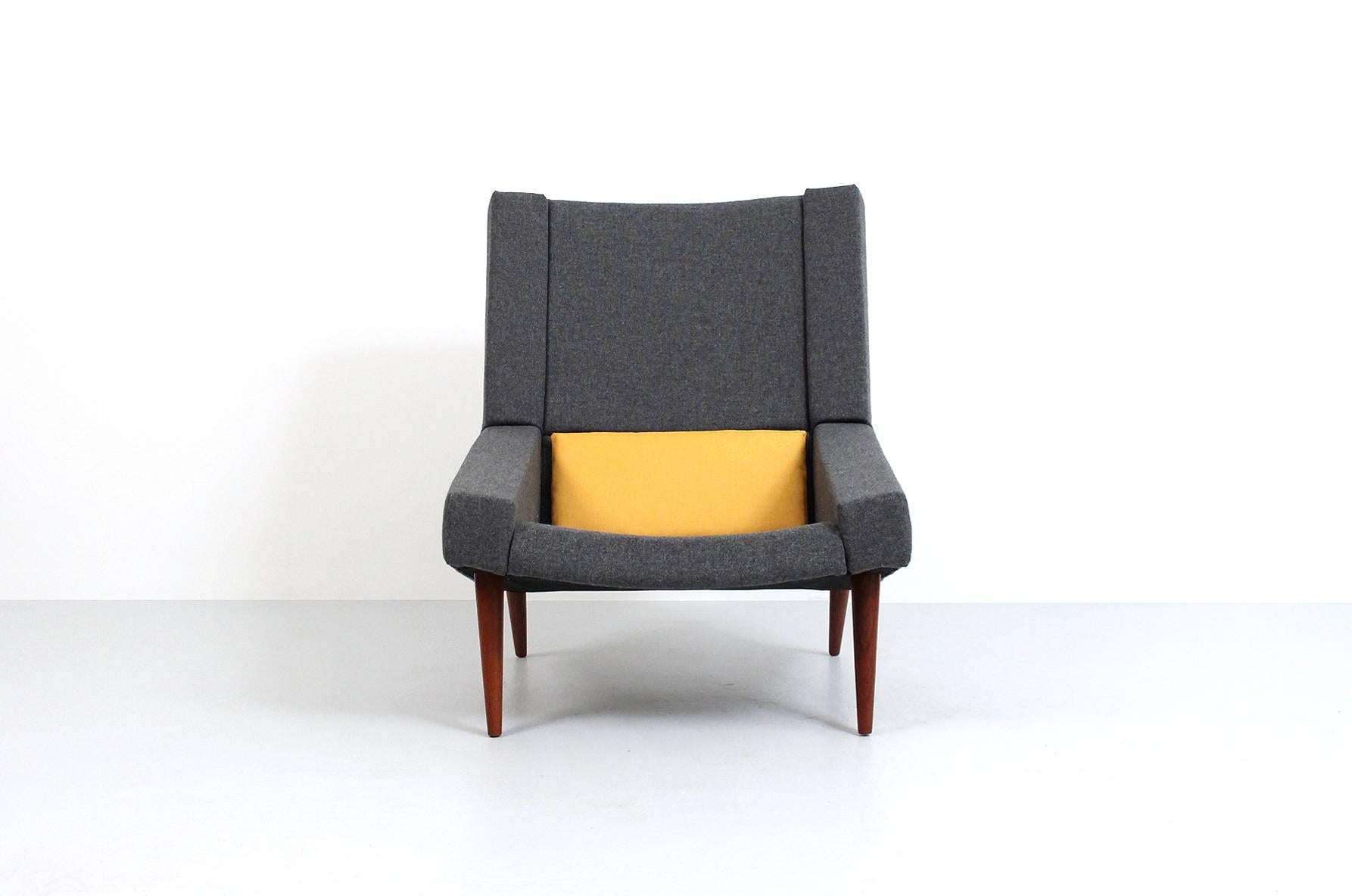 Rare pair of upholstered high back lounge chairs with teak legs designed by Illum Wikkelsø for Soren Willadsen. Incredibly graphic and geometric form. Dark grey fabric is Tonica-182 by Kvadrat.