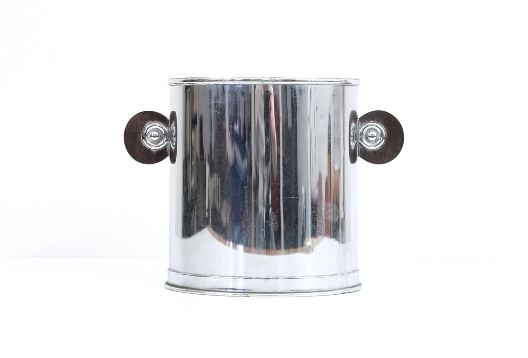 Modernist chrome and wood Champagne/ice bucket. Very graphic form with exotic wood handles on either side.
   