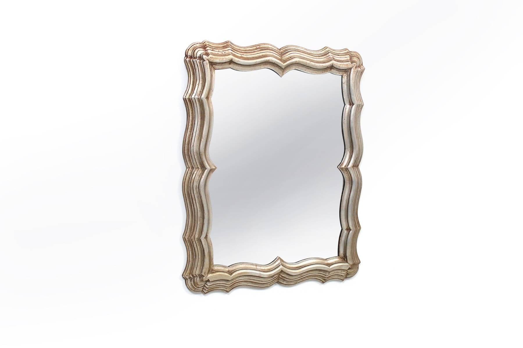Dramatic carved antiqued silver leaf mirror by Dorothy Draper. Statement piece of the highest quality.