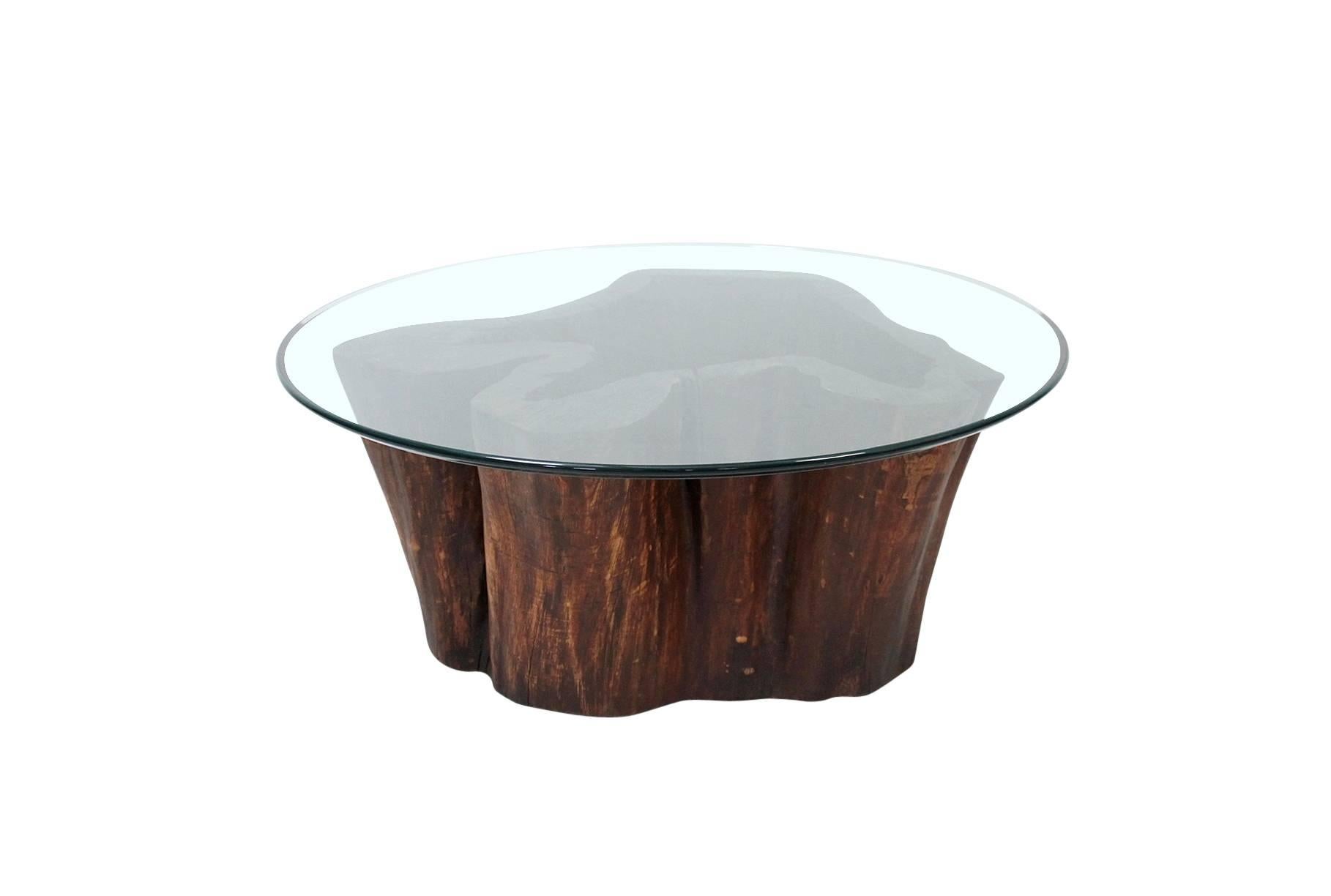 Vintage hollow stump coffee table with round glass top. Great biomorphic and graphic shape. Reminiscent of the 1970s work of famed Brazilian designer José Zanine Caldas. Current top is a 40
