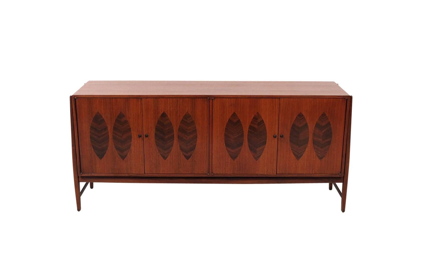Credenza or cabinet designed by Kipp Stewart for the American Design Foundation and Calvin Furniture. Cabinet features four doors with leaf inspired rosewood inlays. Well constructed and styled cabinet.
