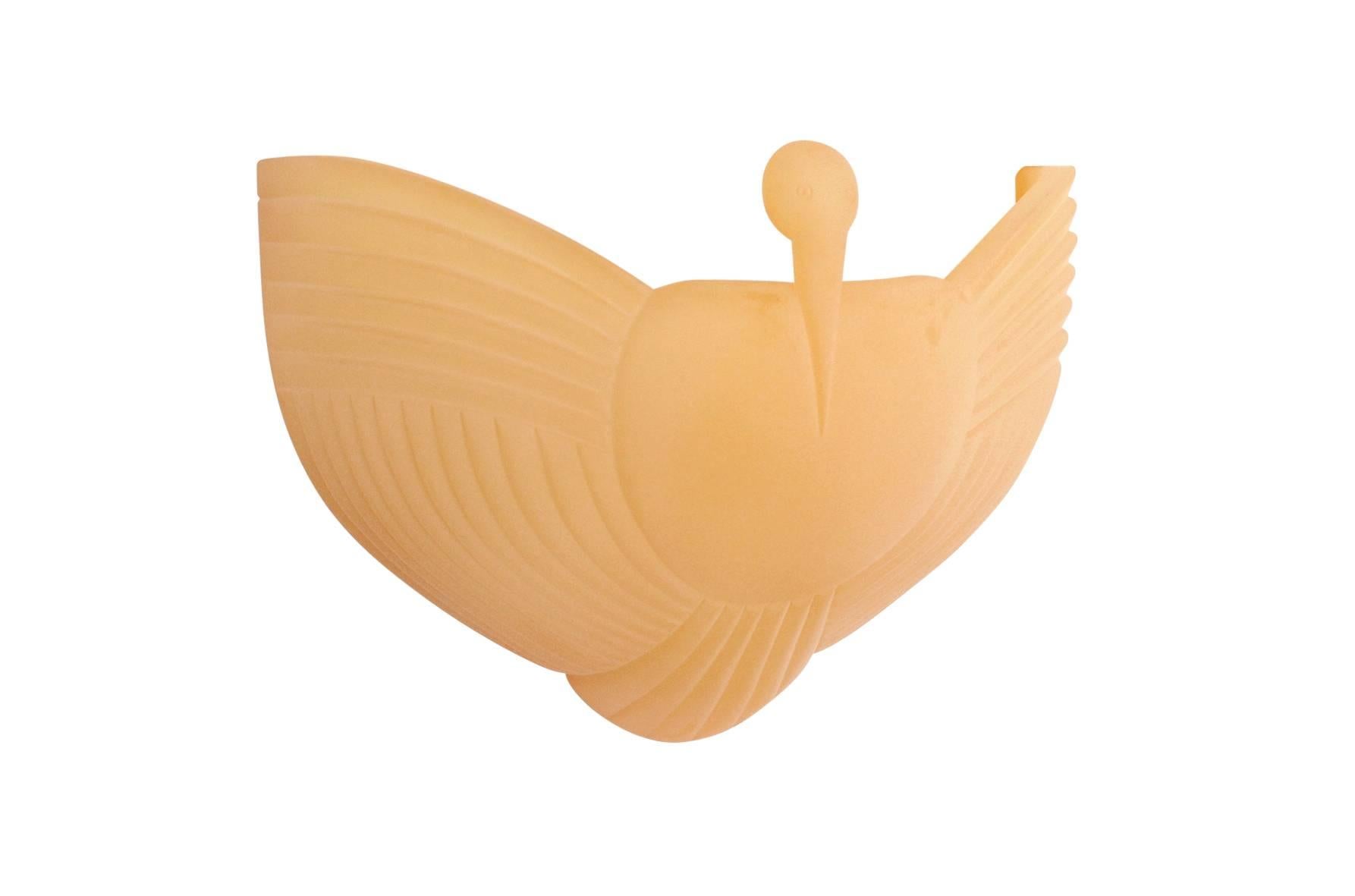 Cast resin wall-mounted sconce by Judy Kensley McKie in the form of a bird. This is from a limited edition of 32 sconces produced in 1997. Signed and numbered to reverse edge.
