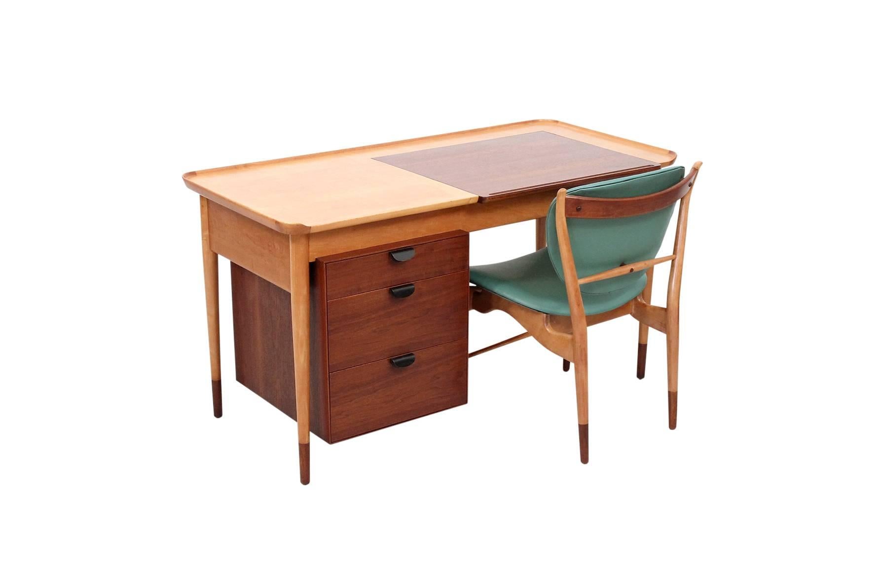 Rare desk or vanity with matching chair designed by Finn Juhl for Baker in 1951. Desk and chair both executed in a combination of walnut and beech. This desk design called by Finn Juhl 