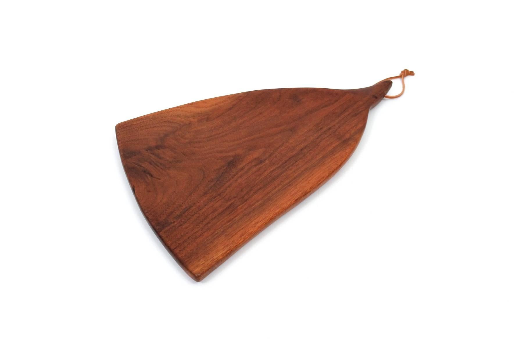Rare cutting board in walnut by exhibited studio furniture maker Dirk Rosse. Sculptural and considered form. Rosse was born in the US, raised in Holland, and settled in Millbrook, NY where he crafted wooden furniture and objects. Signed with his DDR