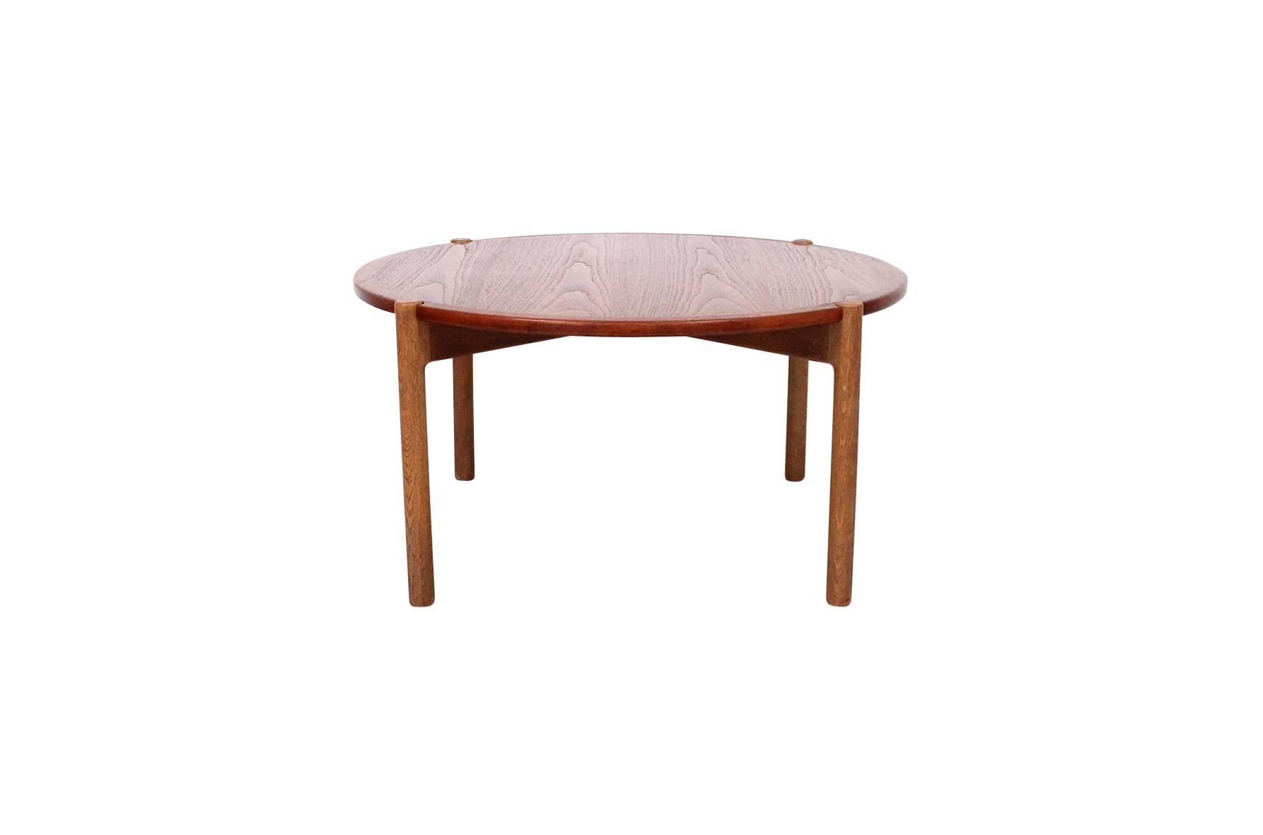 Hans J. Wegner designed coffee table for Johannes Hansen. Top of this table reverses for use with a teak or black laminate surface. Wonderful architectural oak base. Table is known as Model JH 564. Branded with the Johannes Hansen mark to underside
