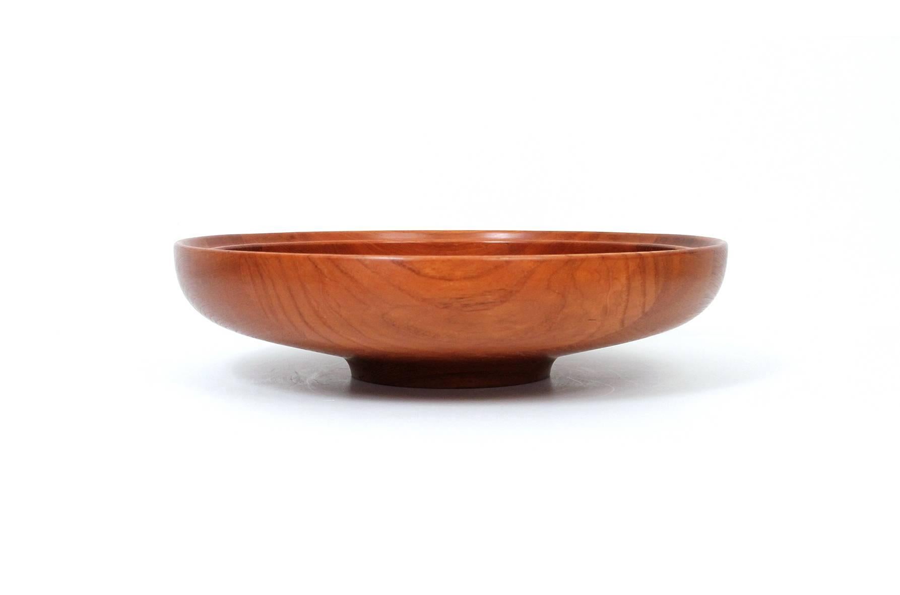 Large-scaled teak serving bowl designed by Henning Koppel for the Danish company Georg Jensen. Beautifully figured and grained solid teak. Branded to underside along with original retailer's label.