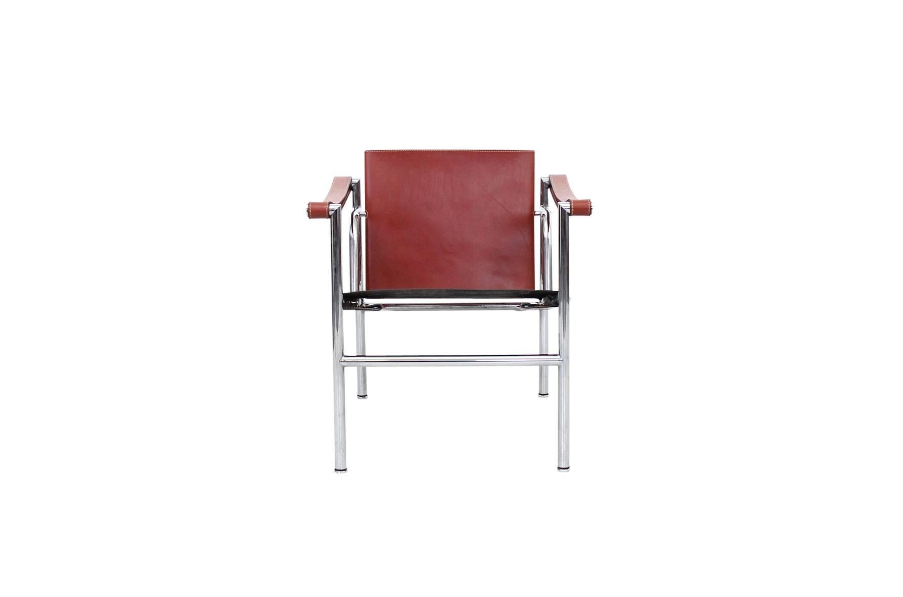 Pair of iconic lounge chairs designed by Le Corbusier and produced by Cassina. Chairs are signed and stamped. These are model LC1 and feature a rare ox blood red leather. Two pairs available.
 