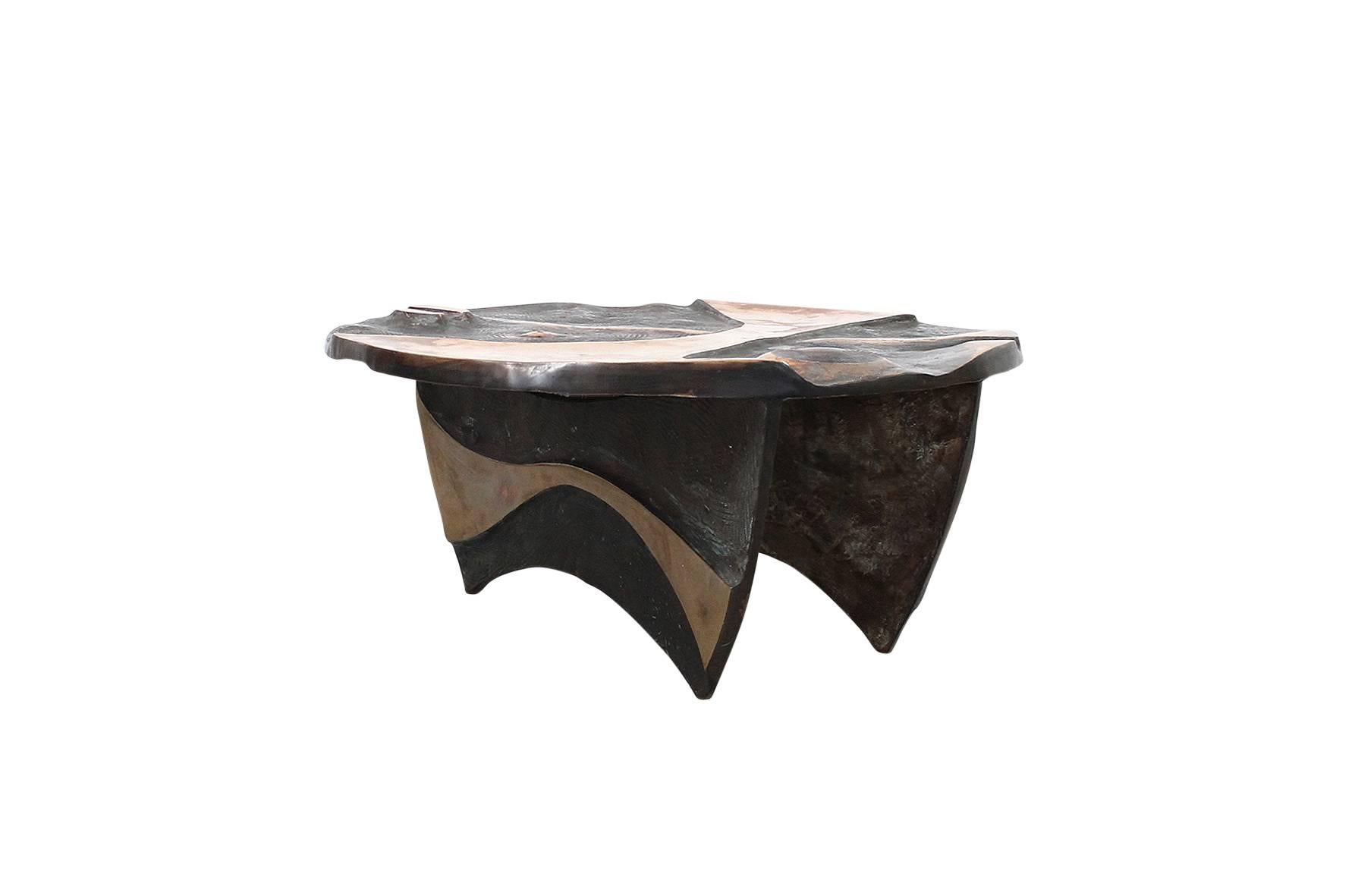Custom designed bronze coffee table by well-known North Carolina sculptor Wayne Trapp. Abstractly carved top is reminiscent of Isamu Noguchi's designs for playgrounds. Table can be used with or without glass top.