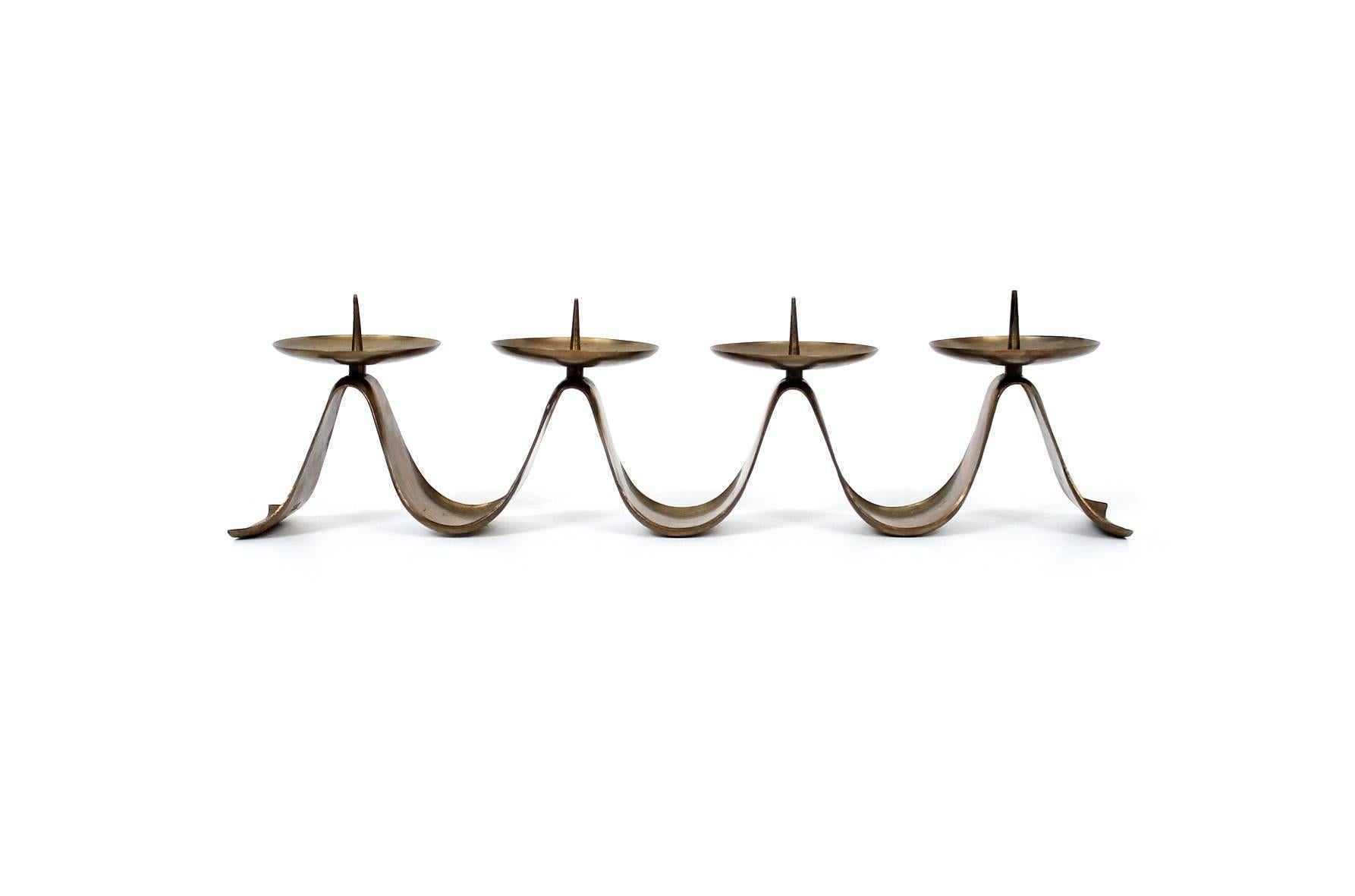 Modernist brass candelabra designed by noted German designer Hayno Focken. This design will accommodate four larger candles. Signed with Focken's conjoined HF mark.

____

We're offering our customers free domestic shipping on all items during the