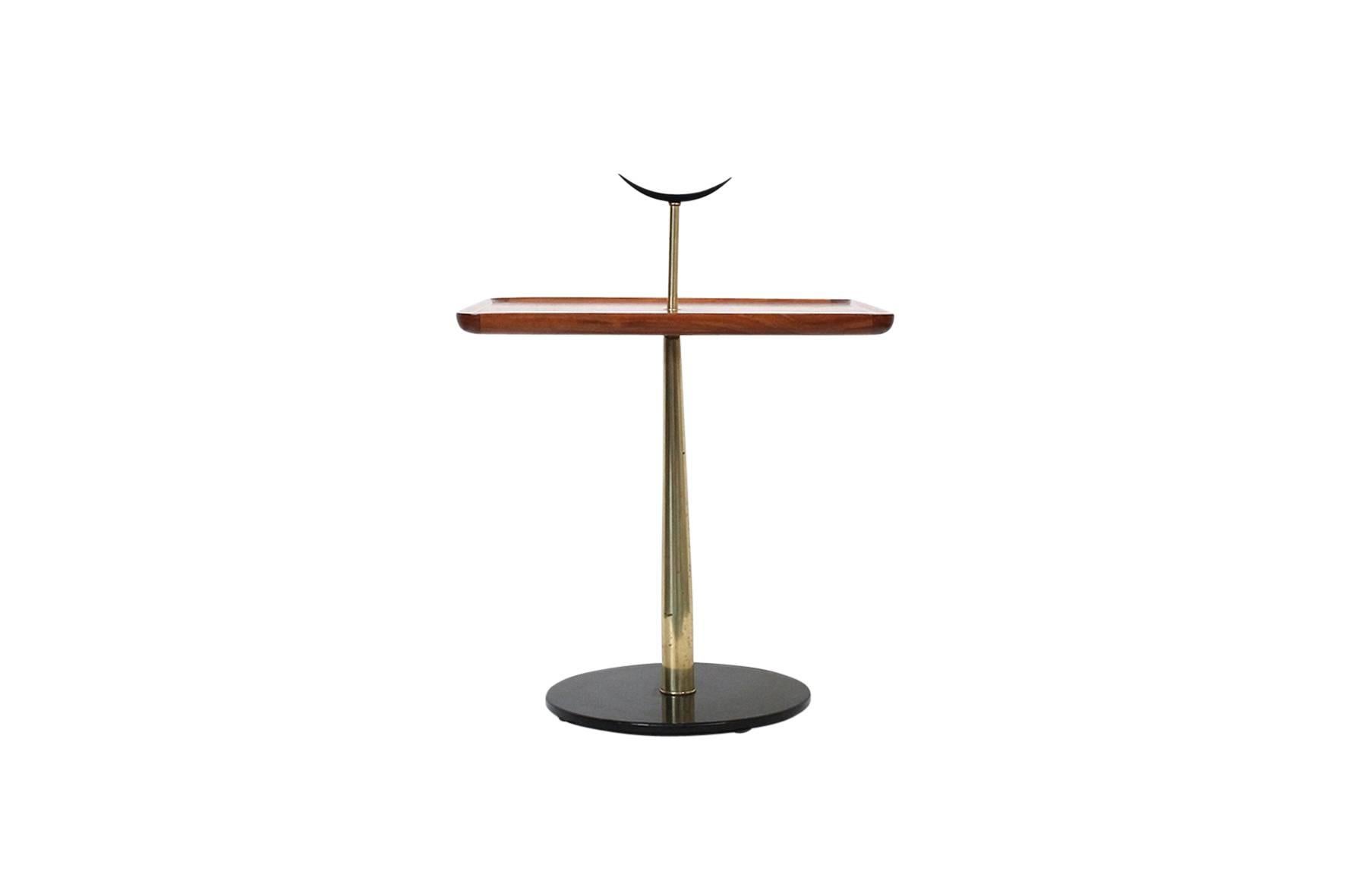 Rare gueridon table designed by Milo Baughman for Arch Gordon in the 1950s. Crescent form handle, walnut top, brass and black enameled base.
  