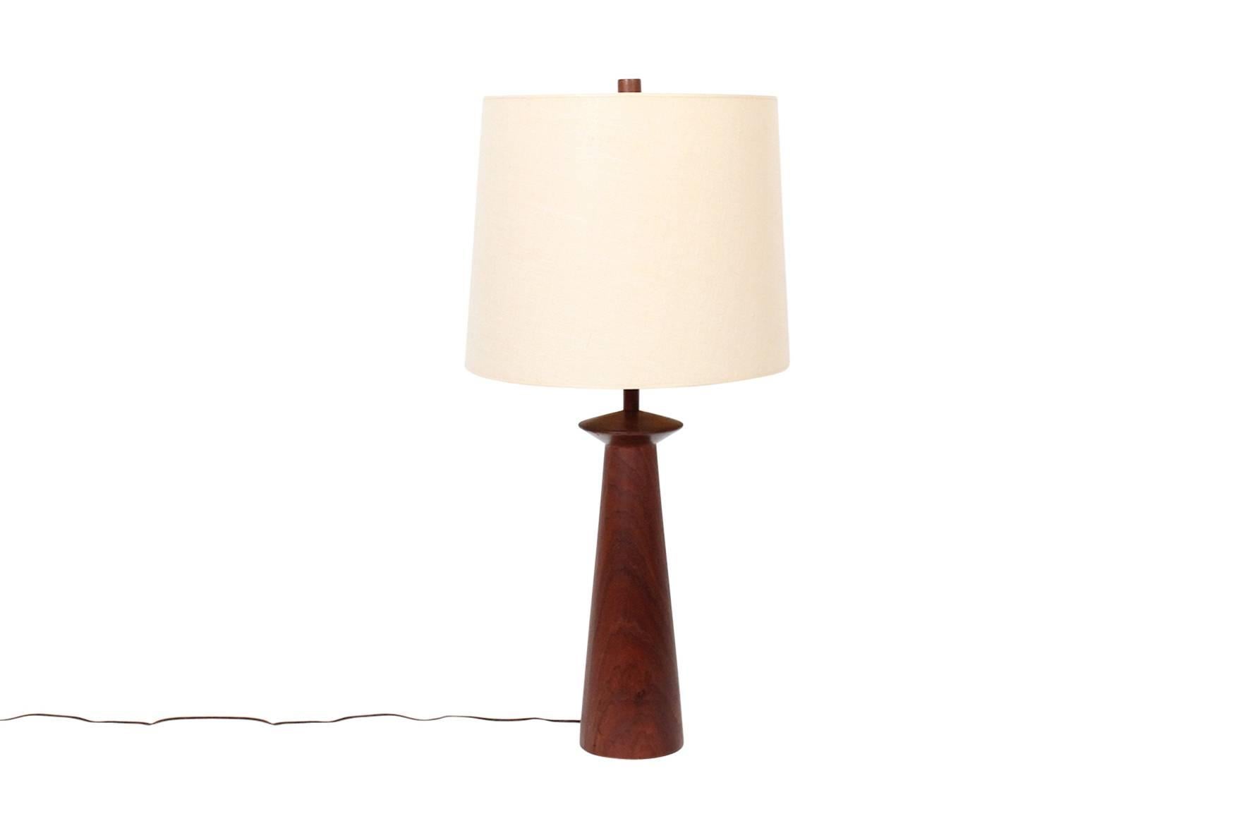 Unique pair of table lamps in walnut designed by Jane and Gordon Martz for Marshall Studios. This is lamp model "W7". Lamps include the Martz's iconic wooden finials. Dimensions below are for lamp with shade shown. Lamp body dimensions: H: